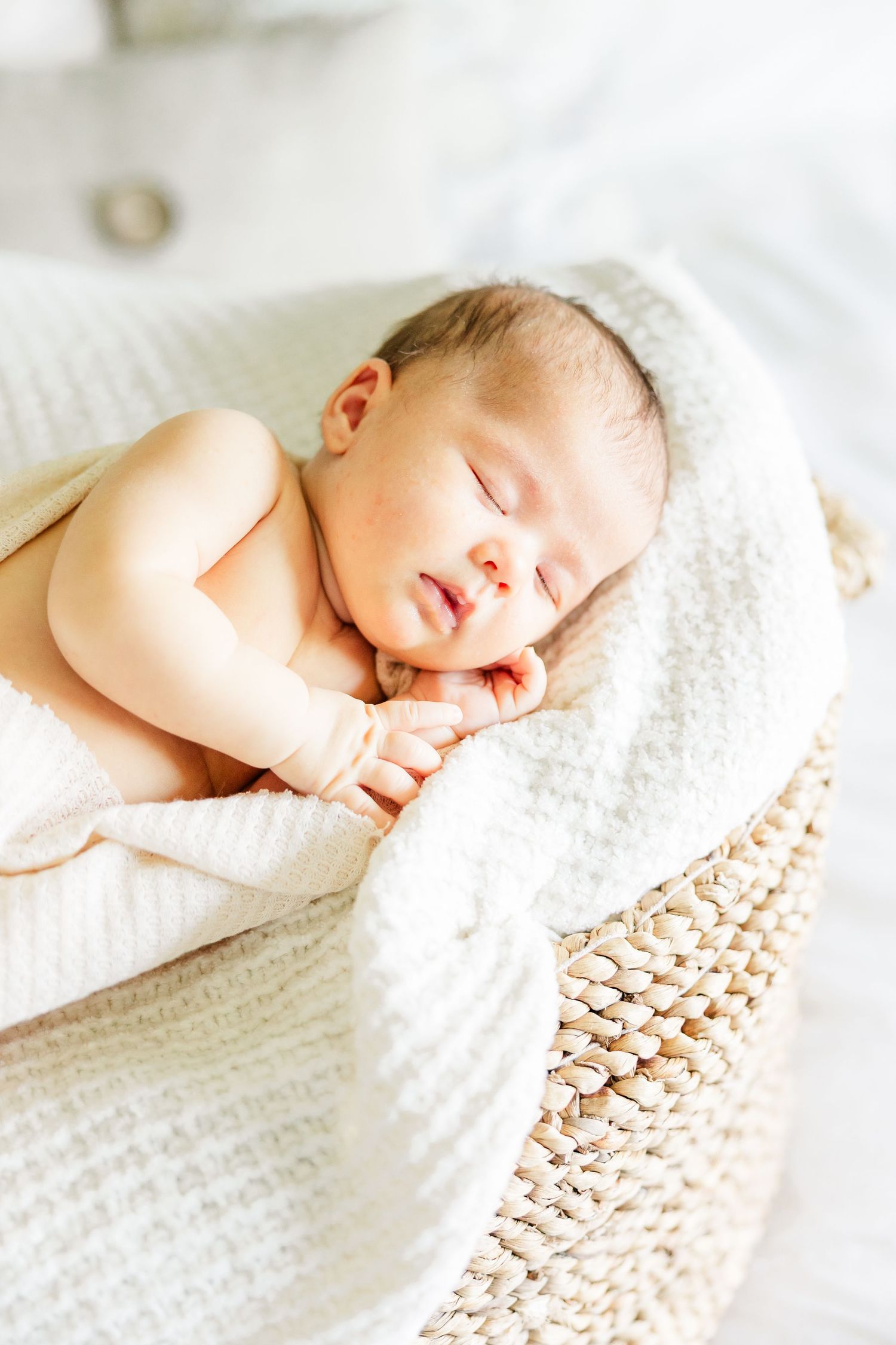 Sleeping newborn baby girl wrapped in a blanket during a Huntley IL lifestyle newborn session