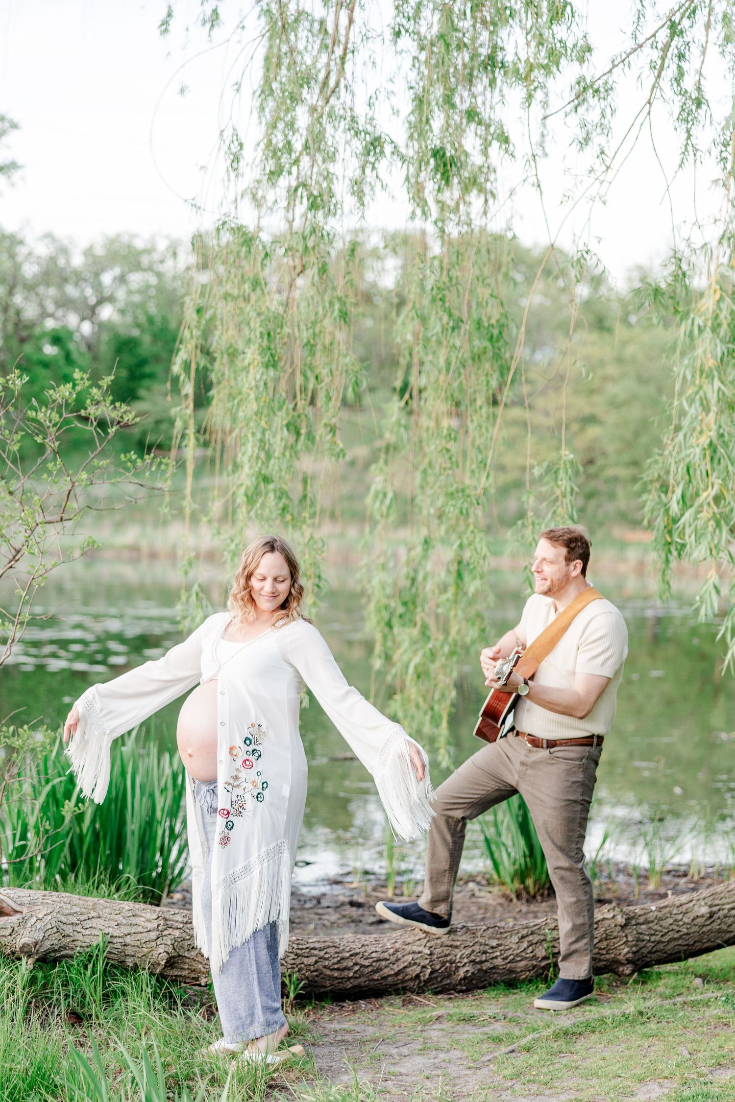Expecting parents with guitar during a playful golden hour maternity session at Veterans Acres Nature Preserve.