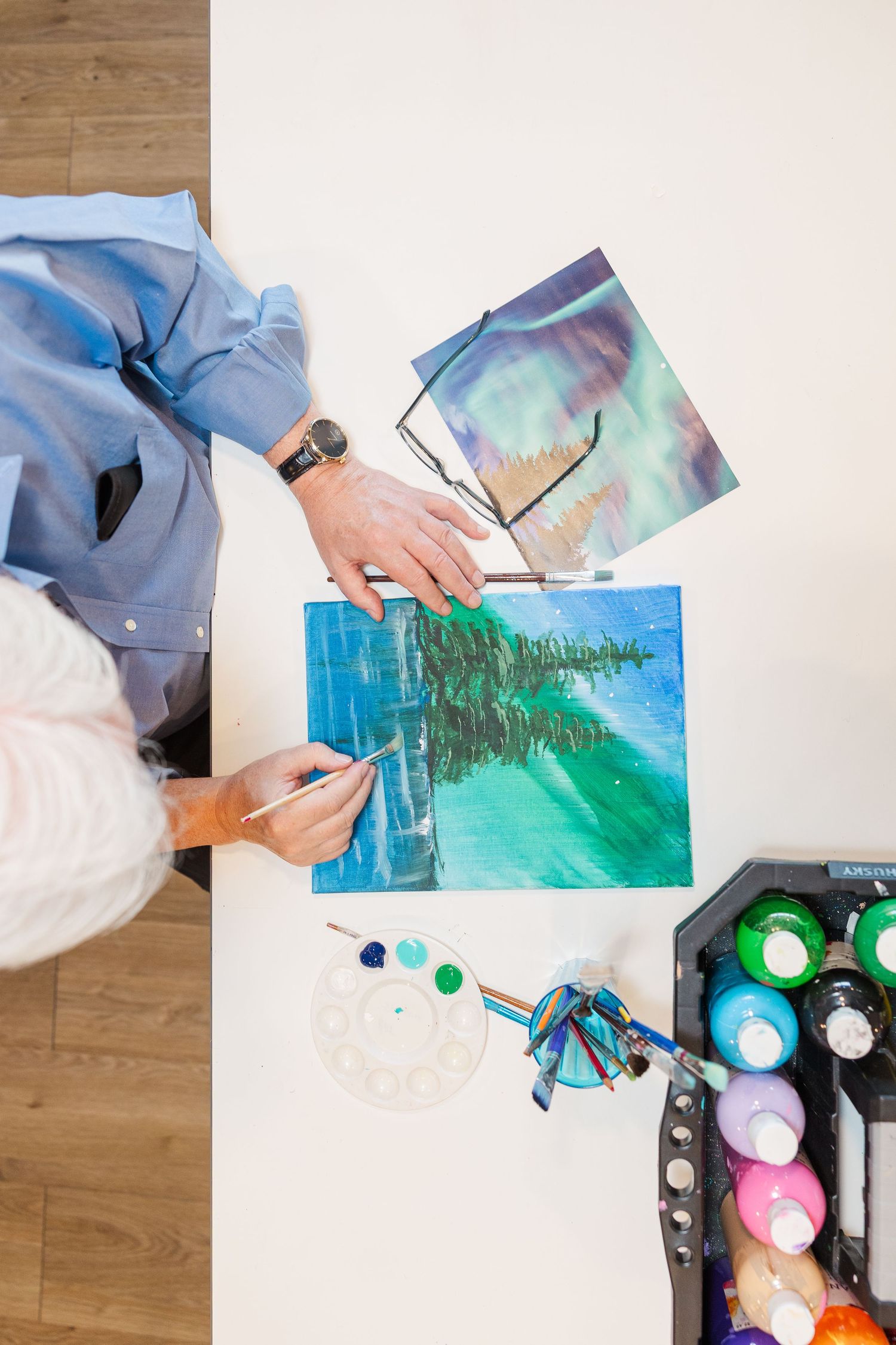 Beacon Hill senior living branding photo in Lombard, Illinois featuring resident painting from overhead view