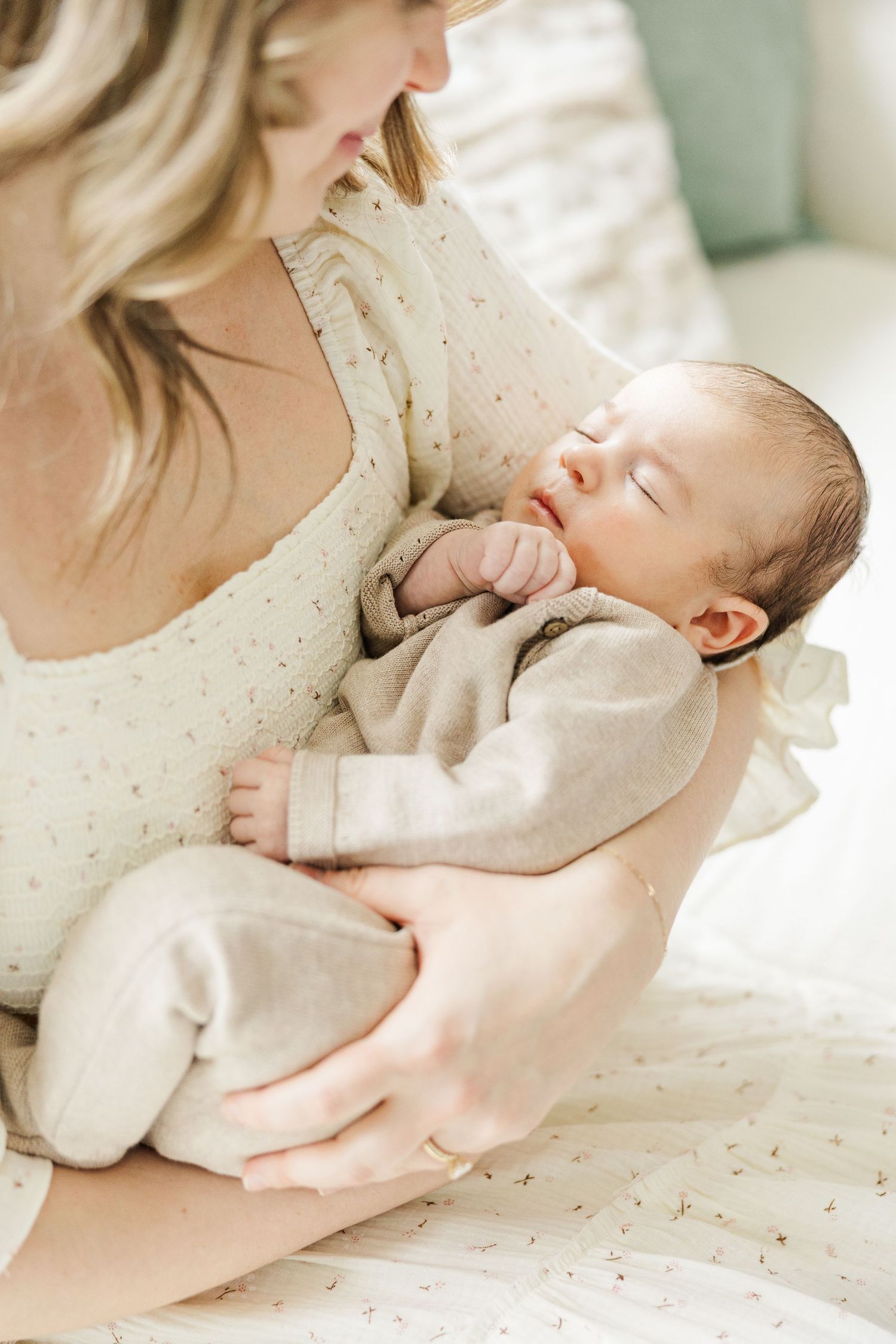 In-home newborn photographer in Palatine Illinois capturing a sleeping baby in mother’s arms during a lifestyle newborn session