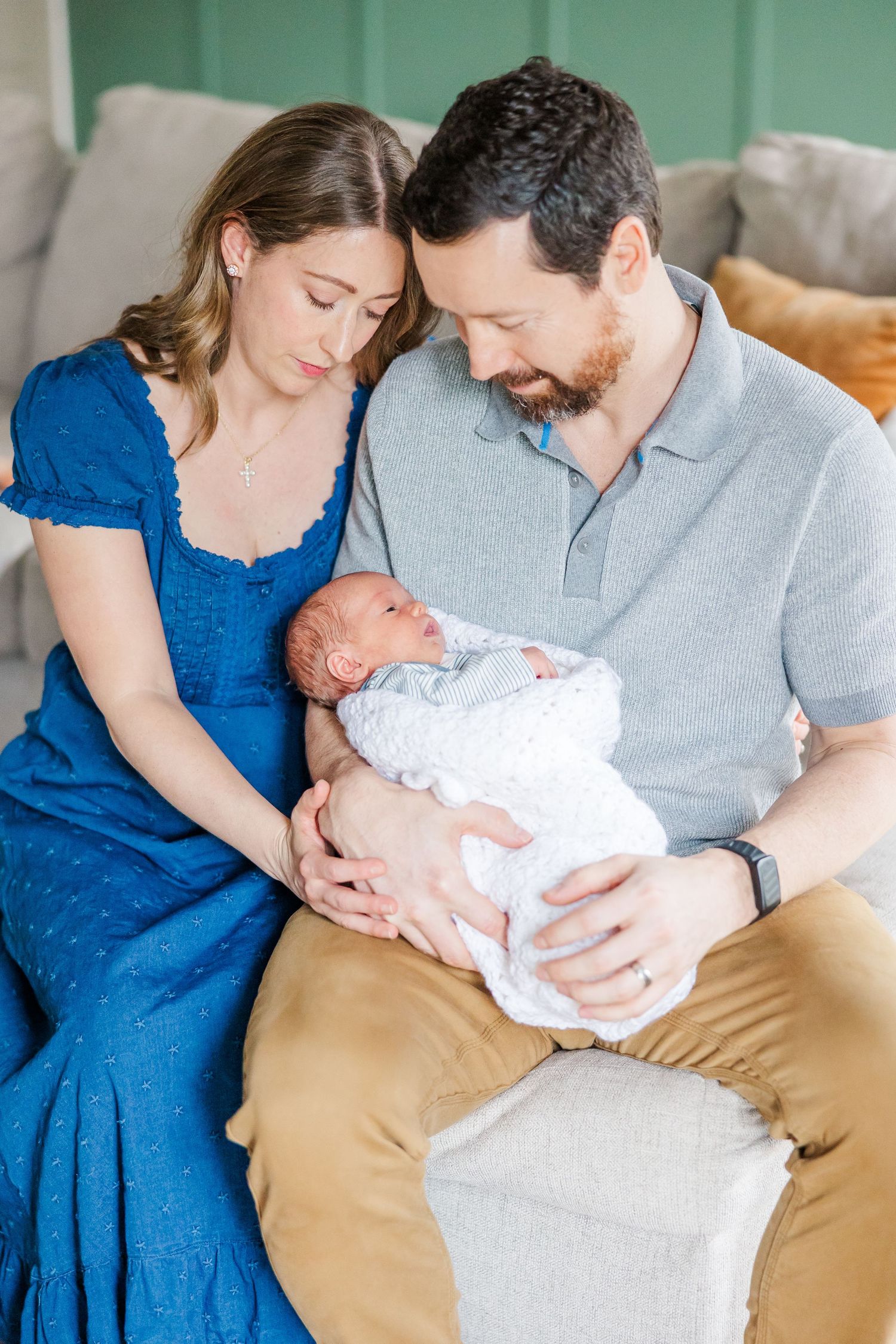 Parents looking at newborn son during in-home lifestyle newborn session in Crystal Lake, Illinois