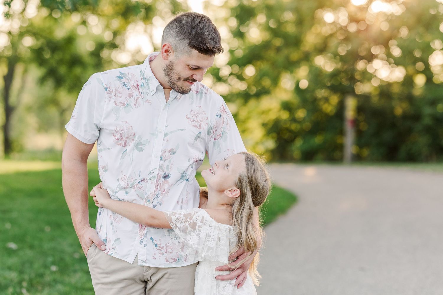 Sweet interaction between two people walking on tree-lined path.