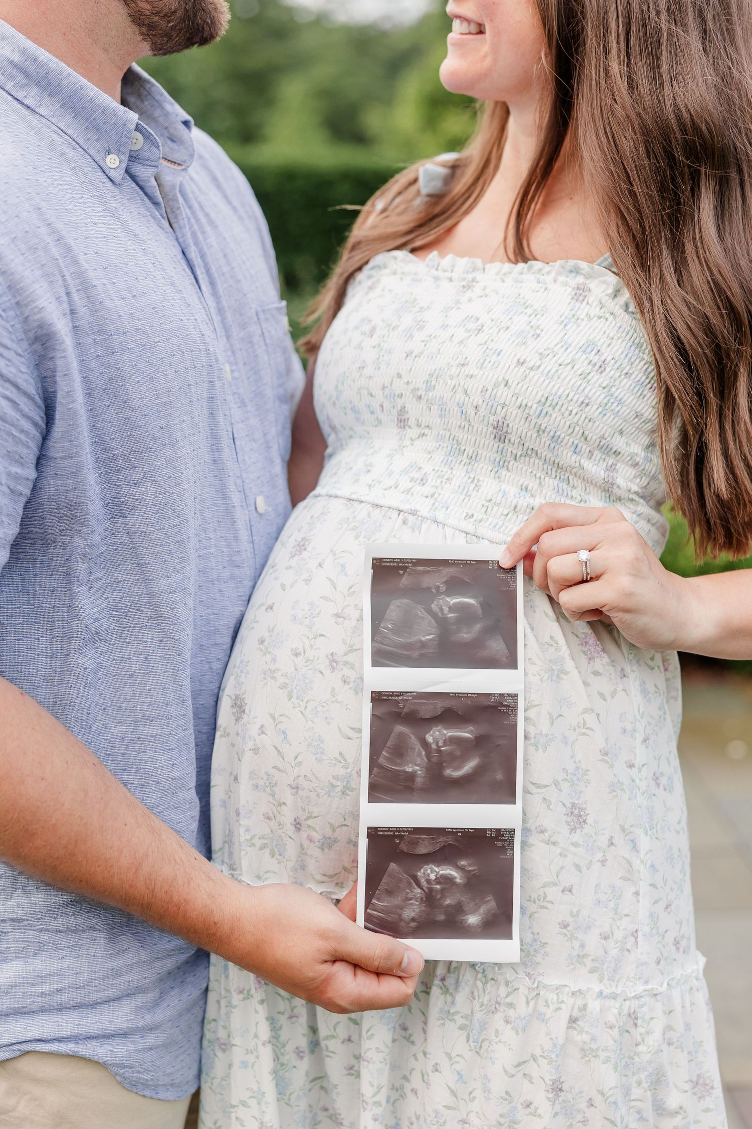 Expecting parents holding ultrasound photos during their Cantigny Park maternity session