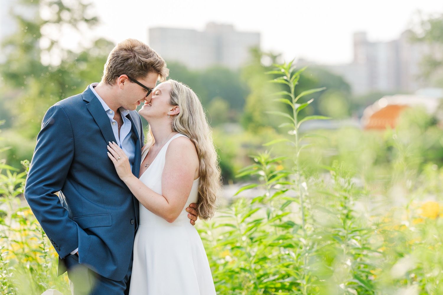 Elizabeth and Joe kissing in the wildflowers on the Lincoln Park Boardwalk in Chicago at sunset
