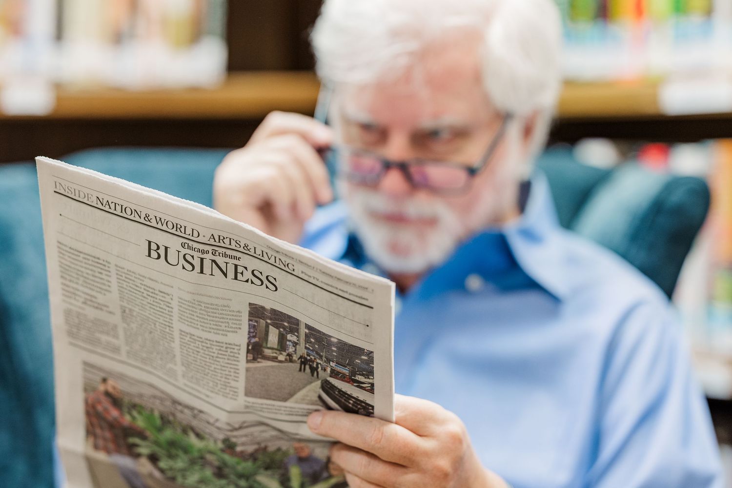 Beacon Hill senior living branding photo in Lombard, Illinois featuring resident reading newspaper