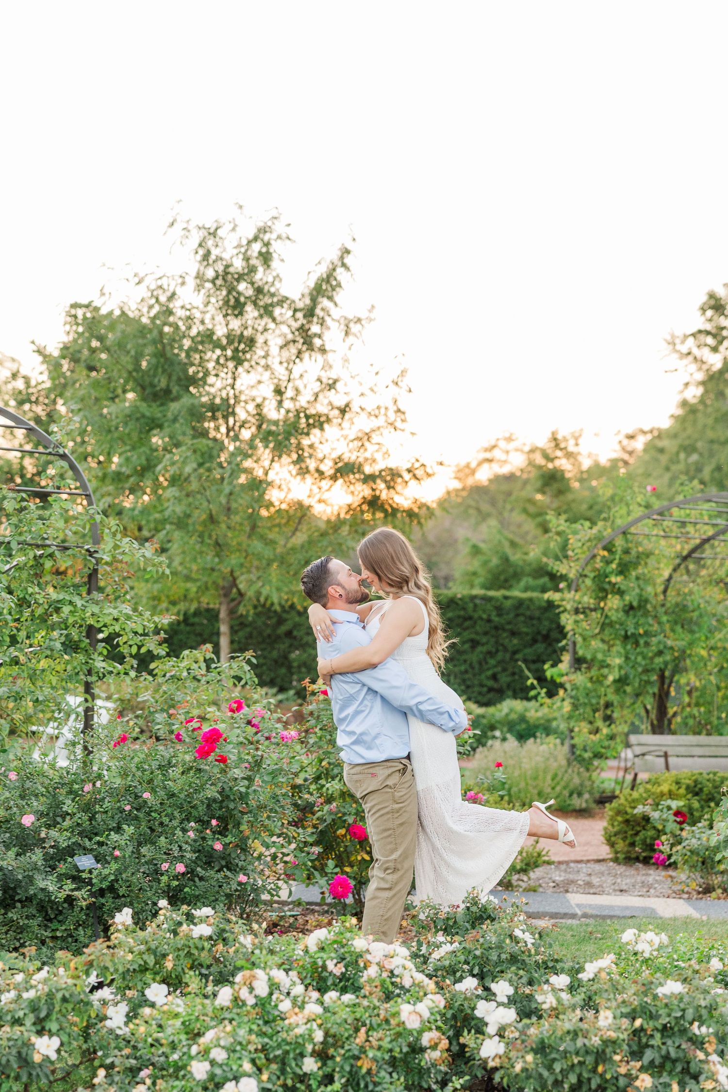 Couple embracing in garden during engagement photos at Cantigny Park in Wheaton, Illinois