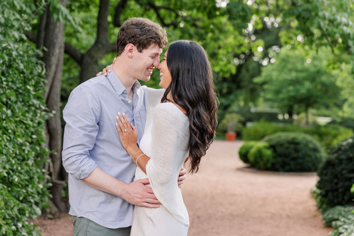 Jack kisses Alysia during their just-engaged portraits at Cantigny Park.
