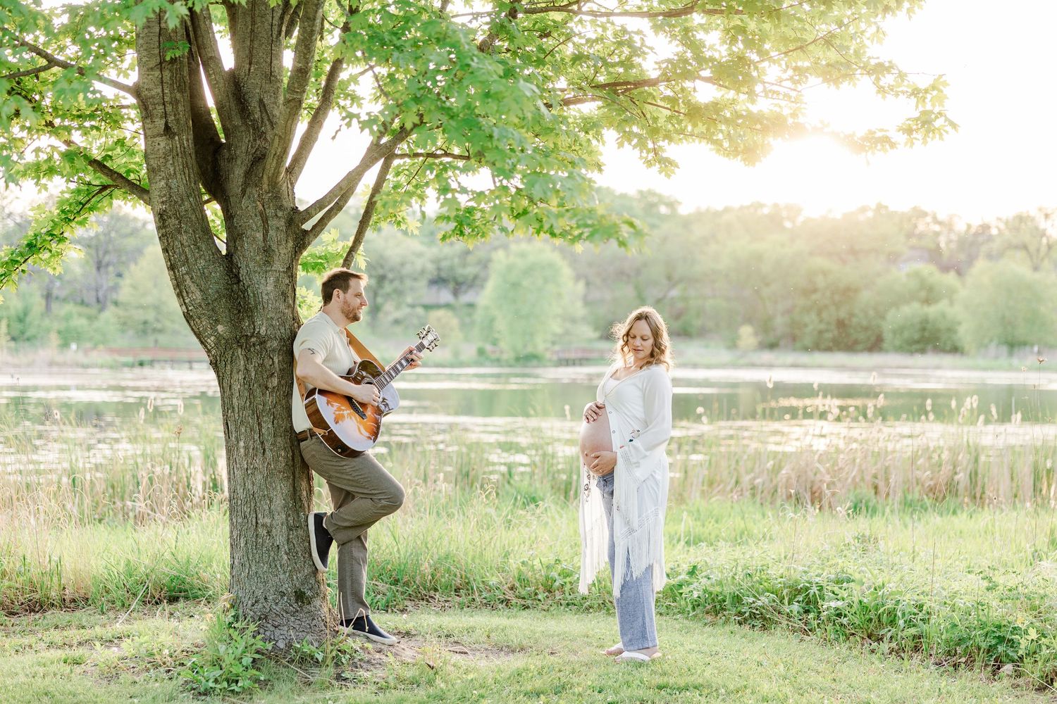 Music-inspired maternity session with father playing guitar at Veterans Acres Nature Preserve.