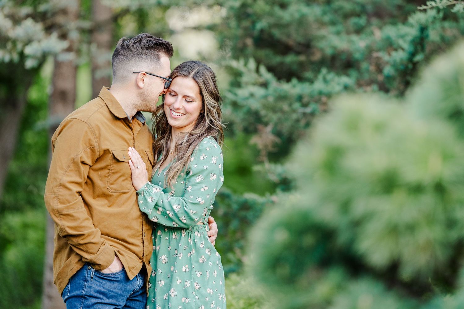 Cantigny Park engagement photo with soft greenery and romantic garden scenery