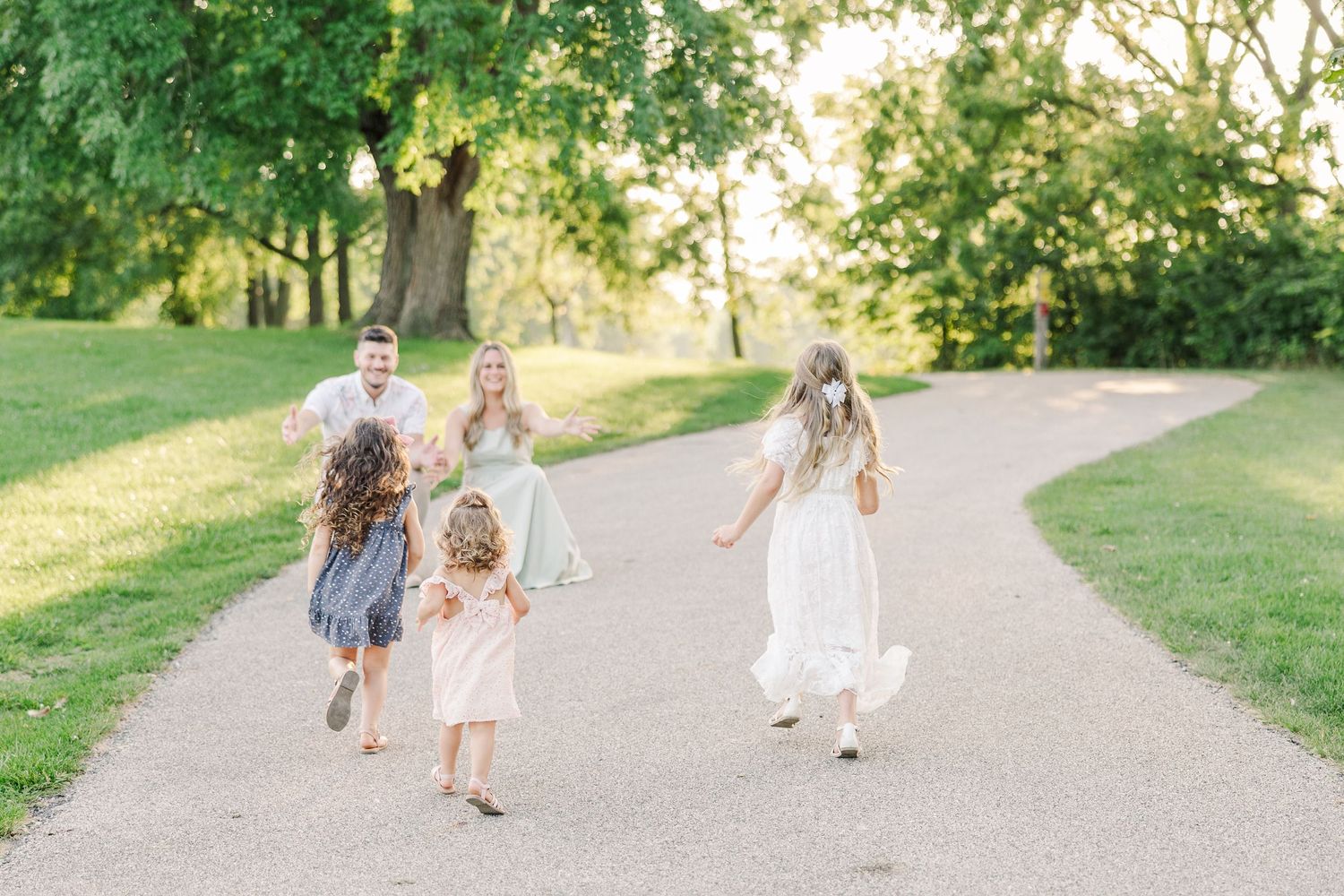 Joyful group running and playing together on a sunlit park pathway.
