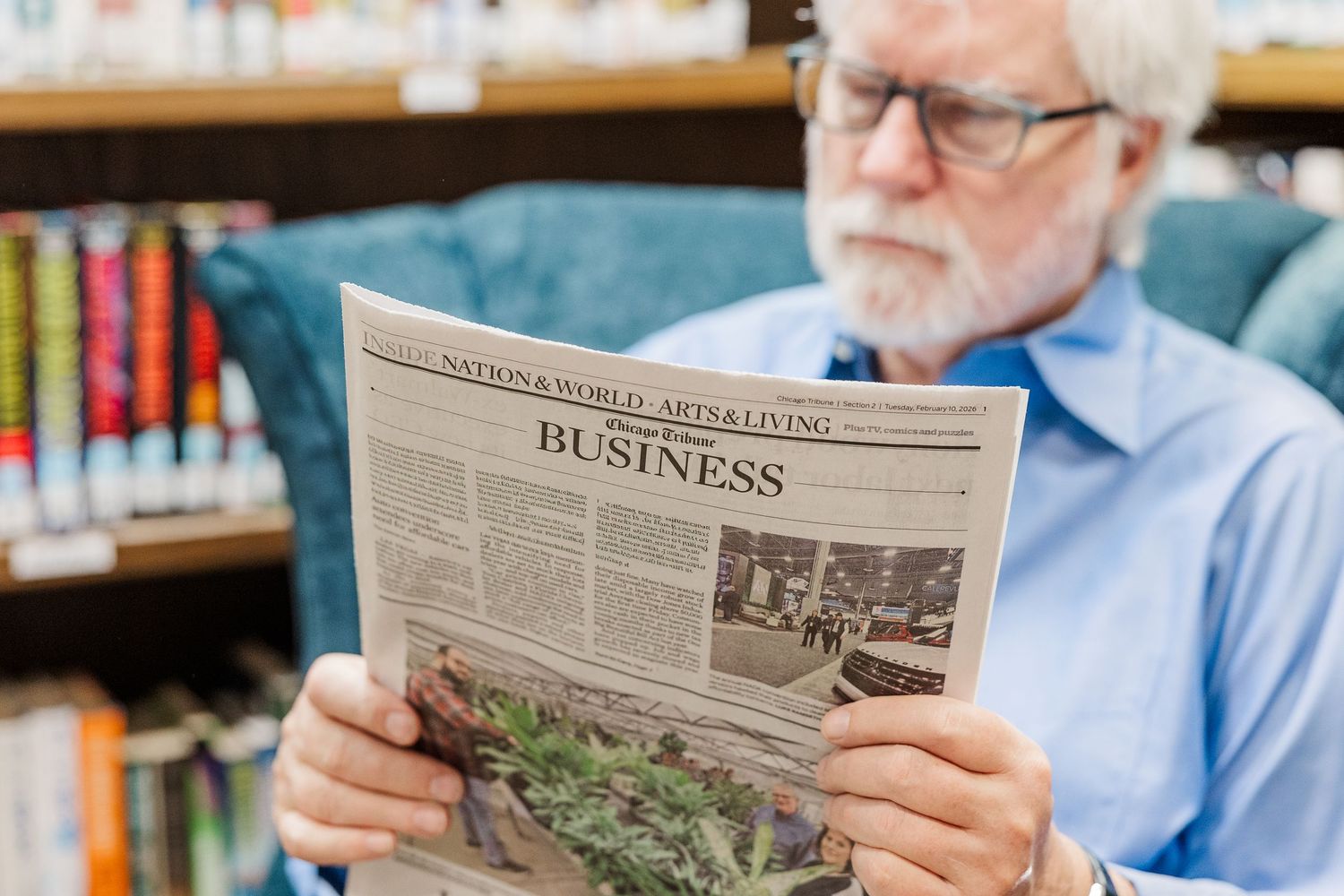 Beacon Hill senior living branding photo in Lombard, Illinois featuring resident reading newspaper in library