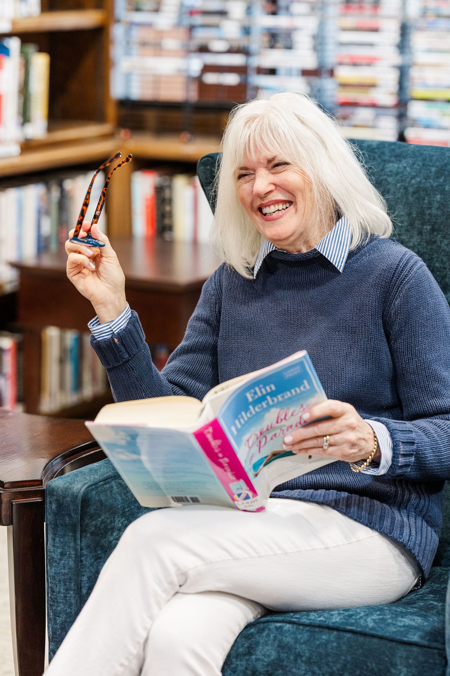 Beacon Hill senior living branding photo in Lombard, Illinois featuring resident reading in library chair