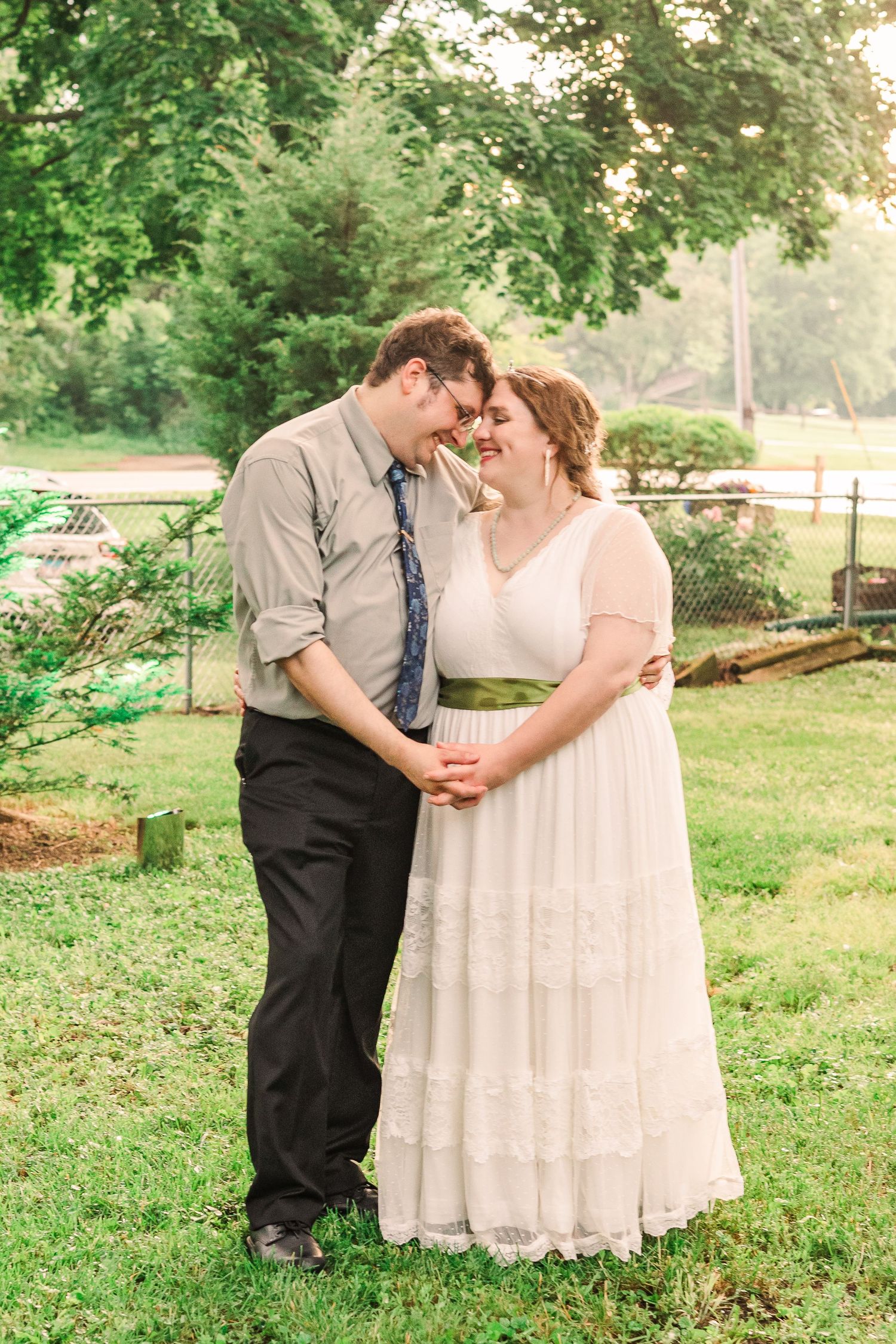 A romantic wedding moment captured in a lush garden setting with soft natural lighting.