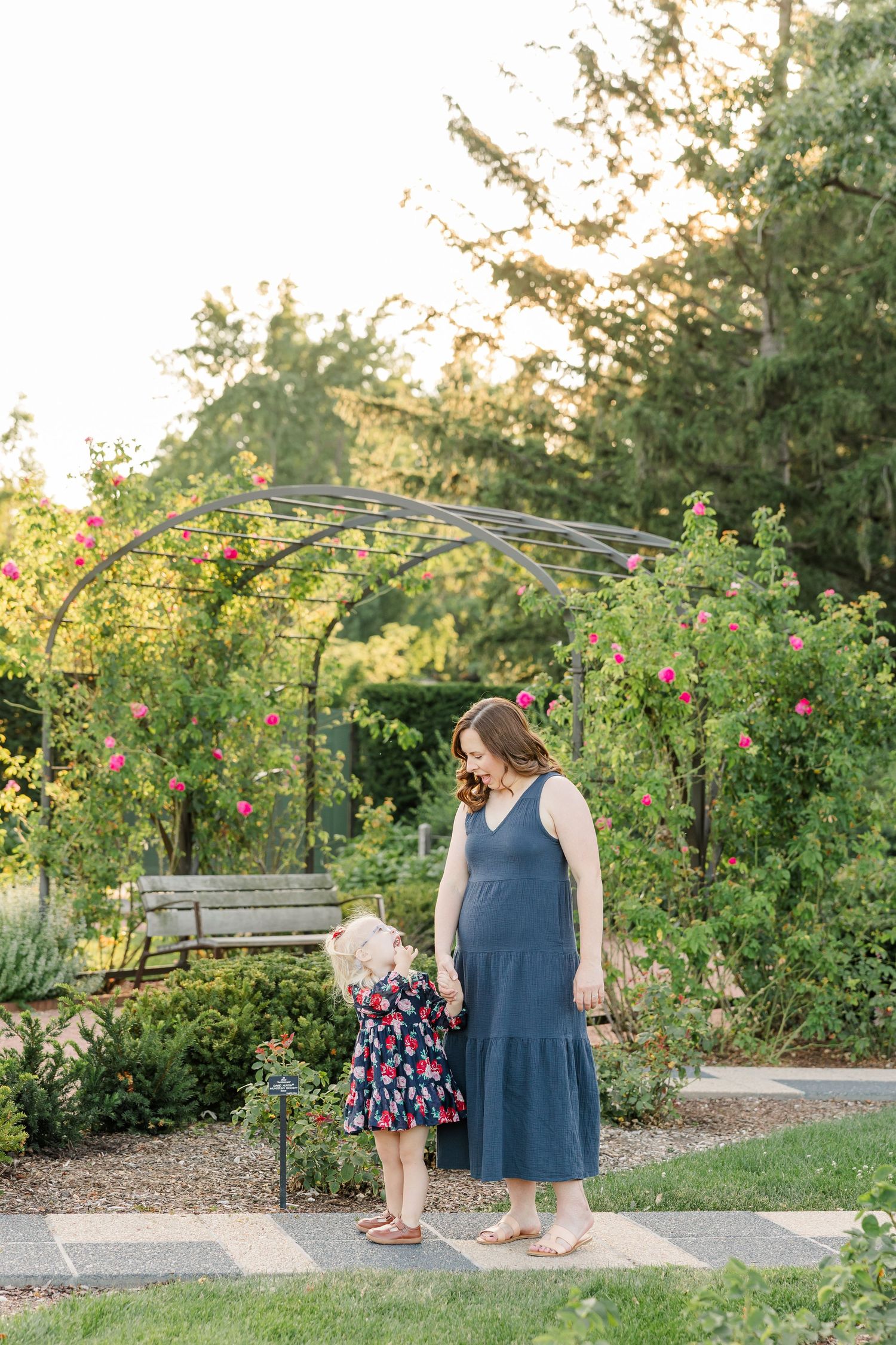 Hilary walking hand in hand with Caroline through the gardens during their Cantigny Park family session.