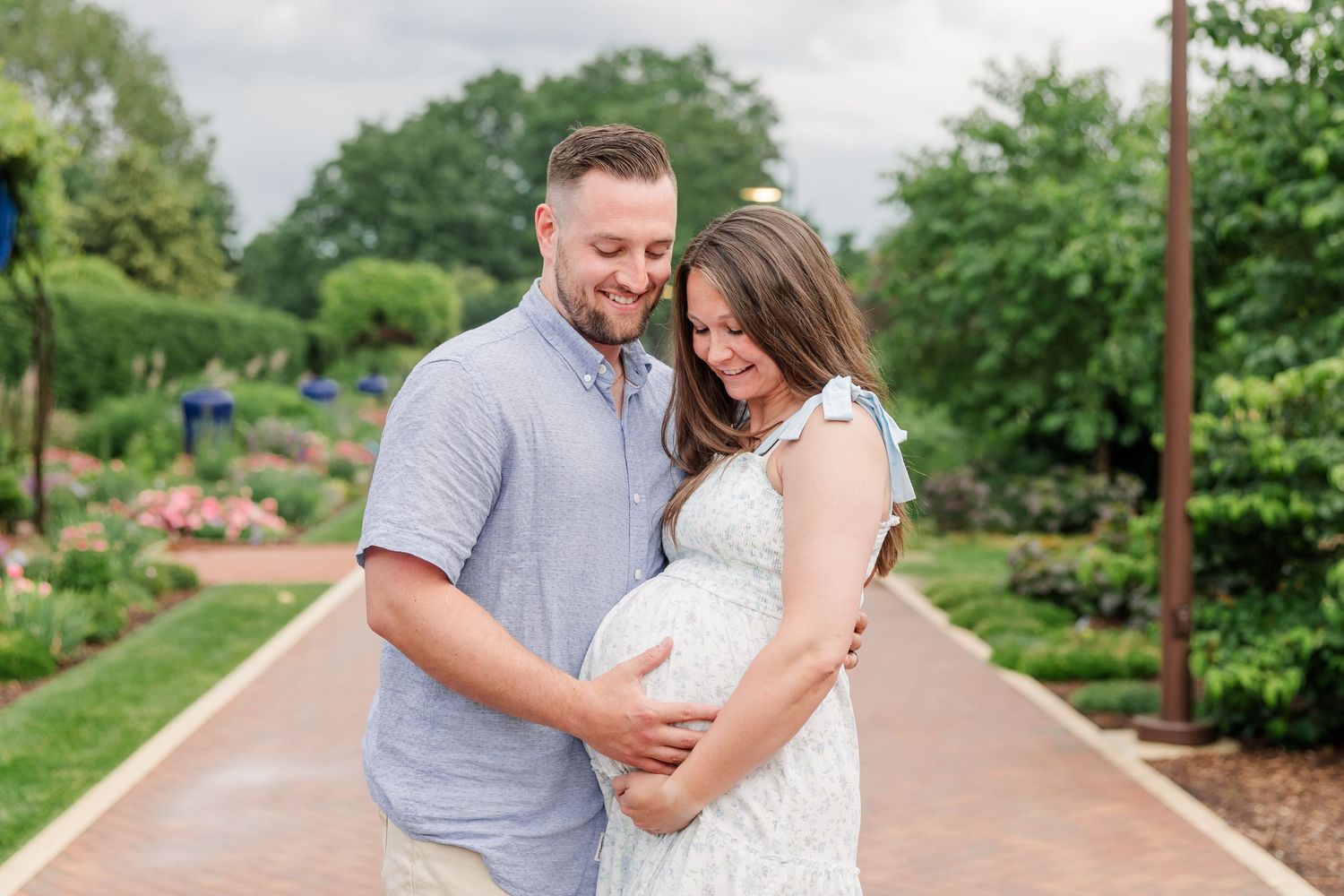 Expecting parents laughing together during a joyful Cantigny Park maternity session