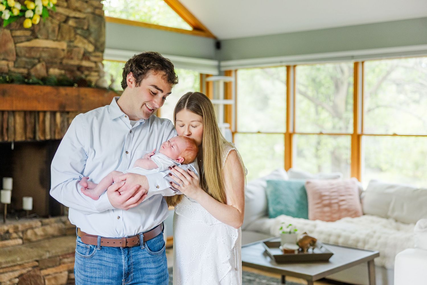 In-home newborn session in Vernon Hills, Illinois with parents holding their newborn during bump to baby experience