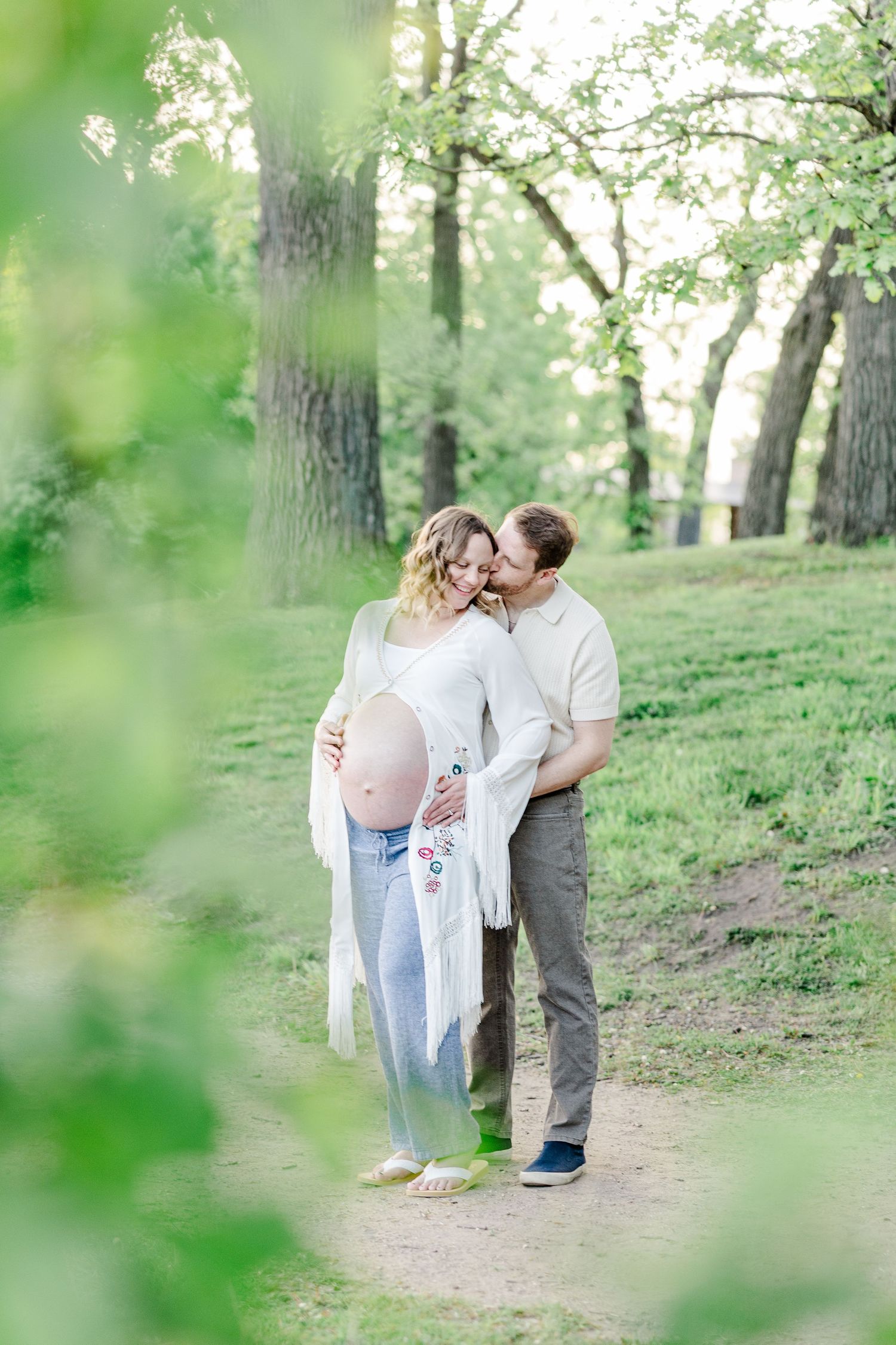 Romantic maternity portrait framed by greenery at Veterans Acres Nature Preserve in Crystal Lake.