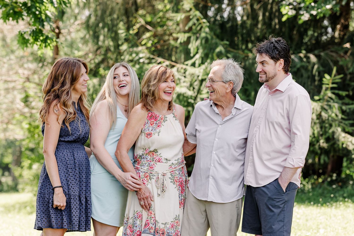Adult children laughing with their parents during an extended family session in Crystal Lake, IL.