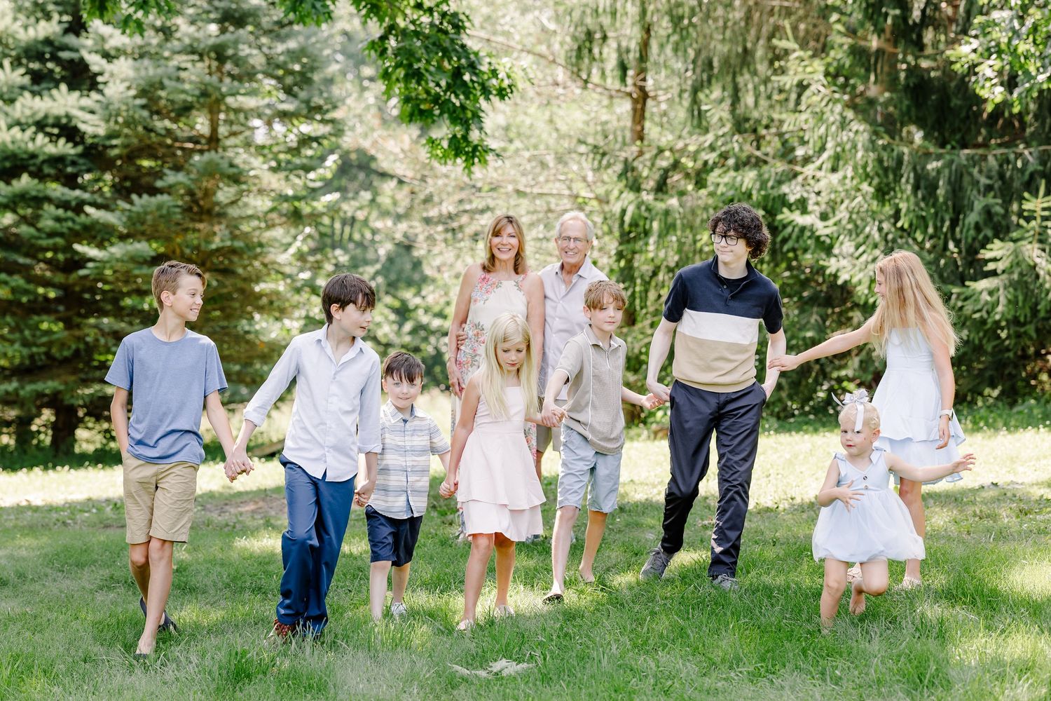 Extended family walking together during a candid summer family session in Crystal Lake, IL.