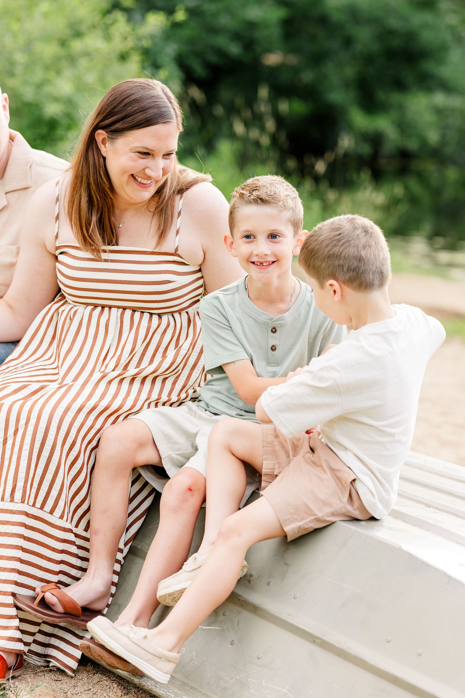 Mom laughing with her two sons during a candid family photo session at Shamrock Hills Park in Crystal Lake.