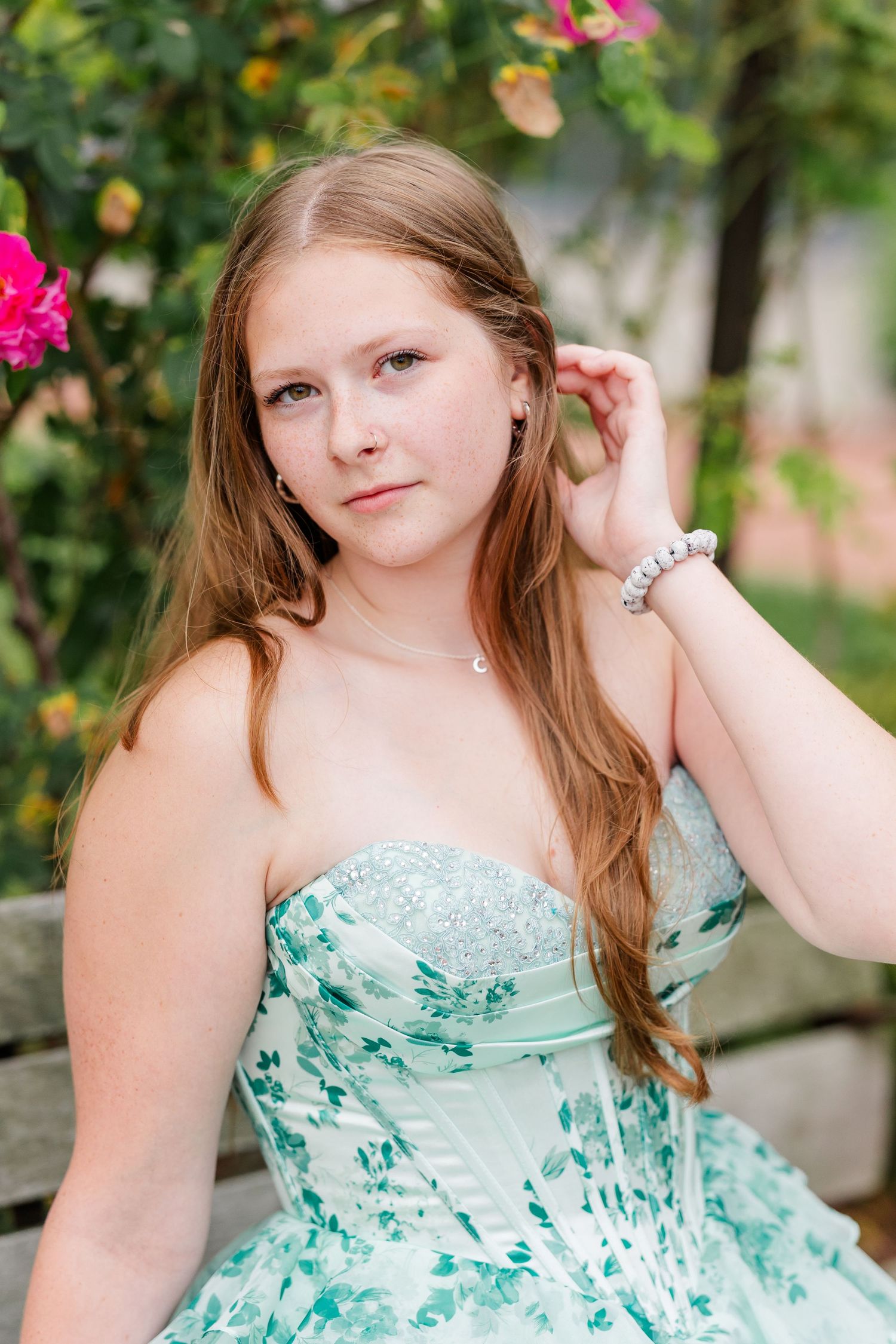 Close-up senior portrait of Samantha wearing a mint floral dress among the colorful Cantigny Park gardens.