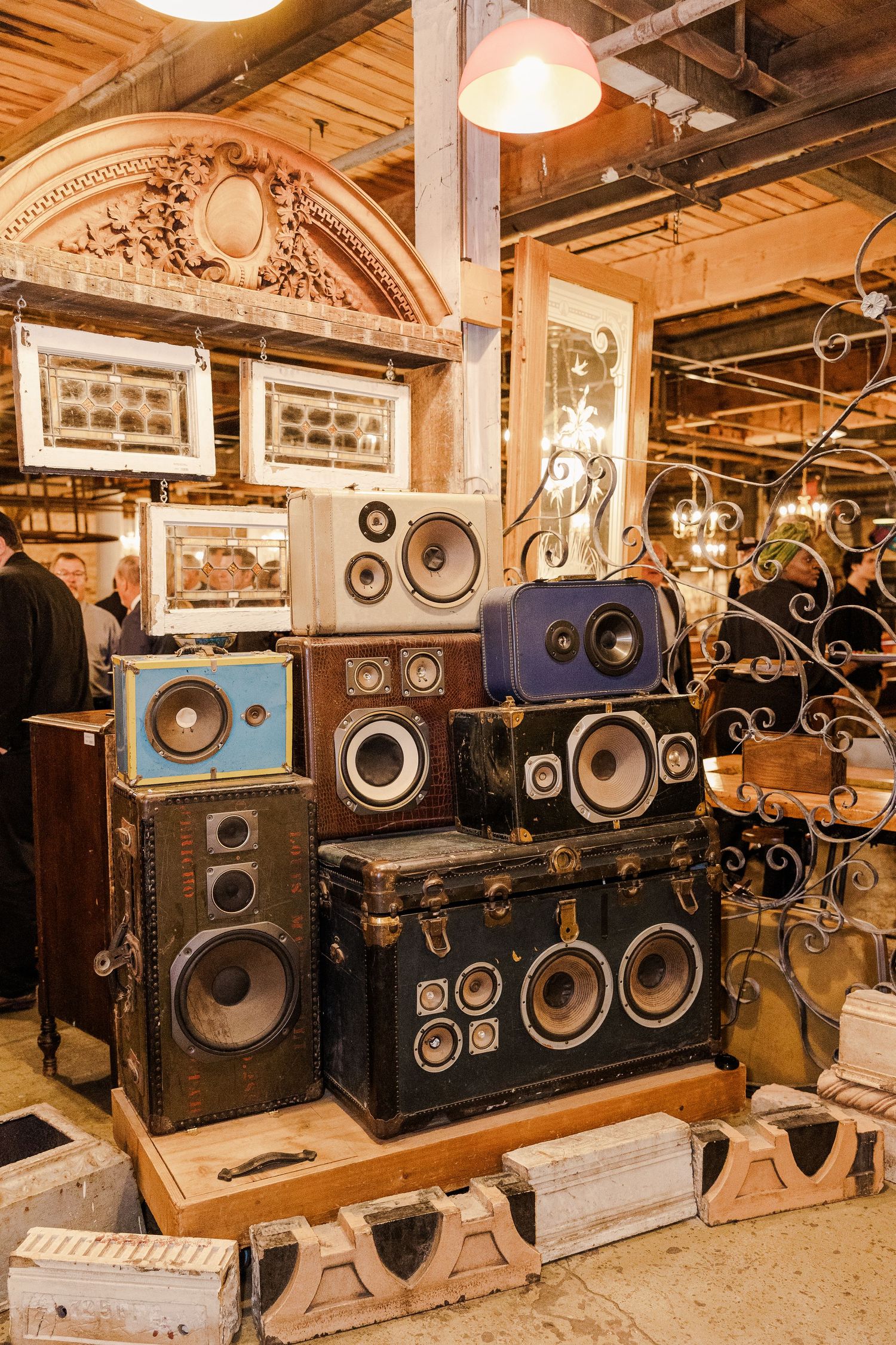Vintage speaker system stacked against ornate architectural backdrop in rustic venue.