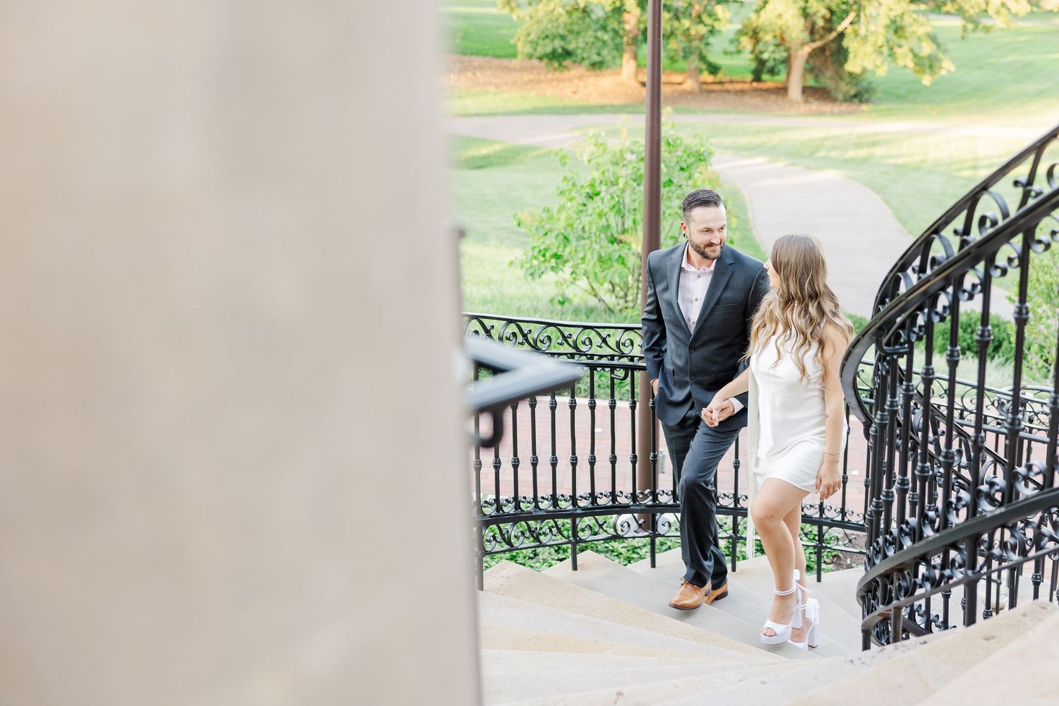 Couple walking down steps during engagement photos at Cantigny Park in Wheaton, Illinois