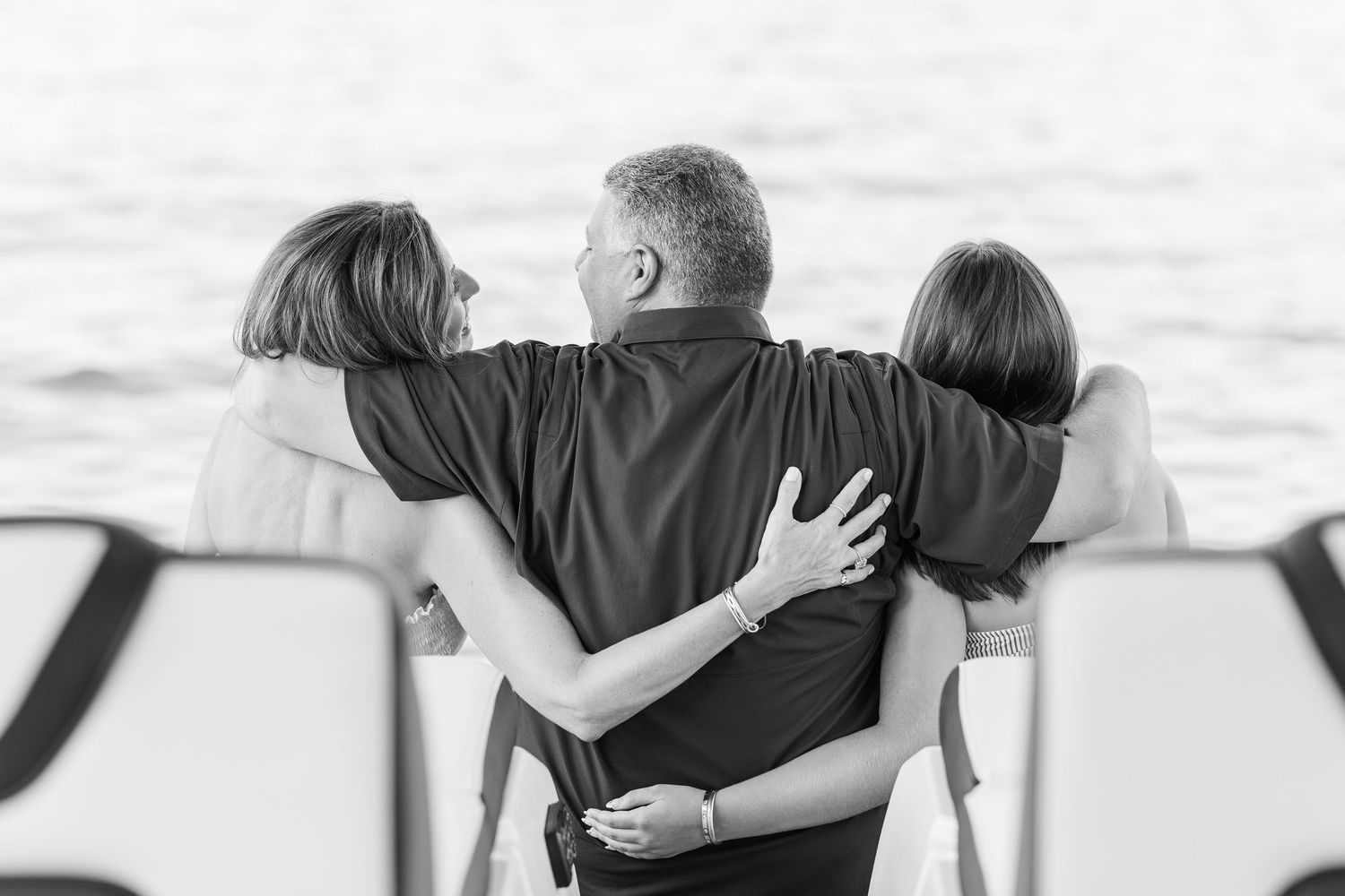 Black and white family portrait from behind on dock at Pistakee Lake