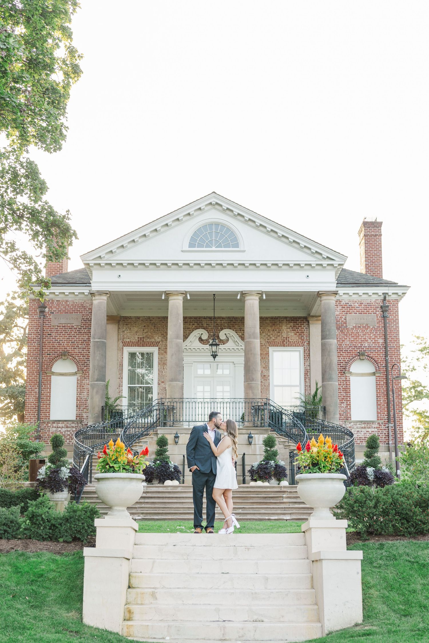 Couple posing on mansion steps during engagement photos at Cantigny Park in Wheaton, Illinois