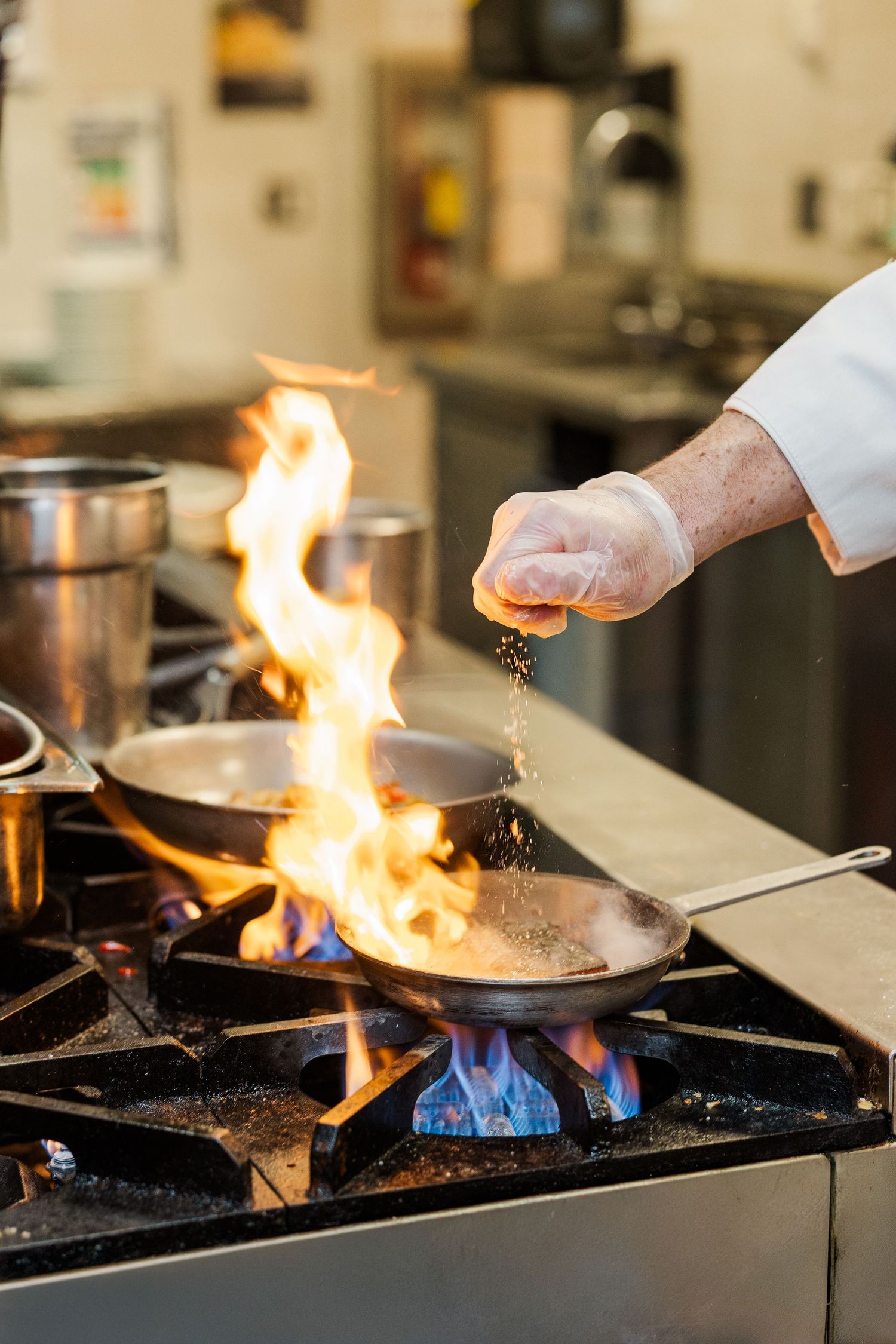 Beacon Hill senior living branding photo in Lombard, Illinois featuring chef cooking in kitchen