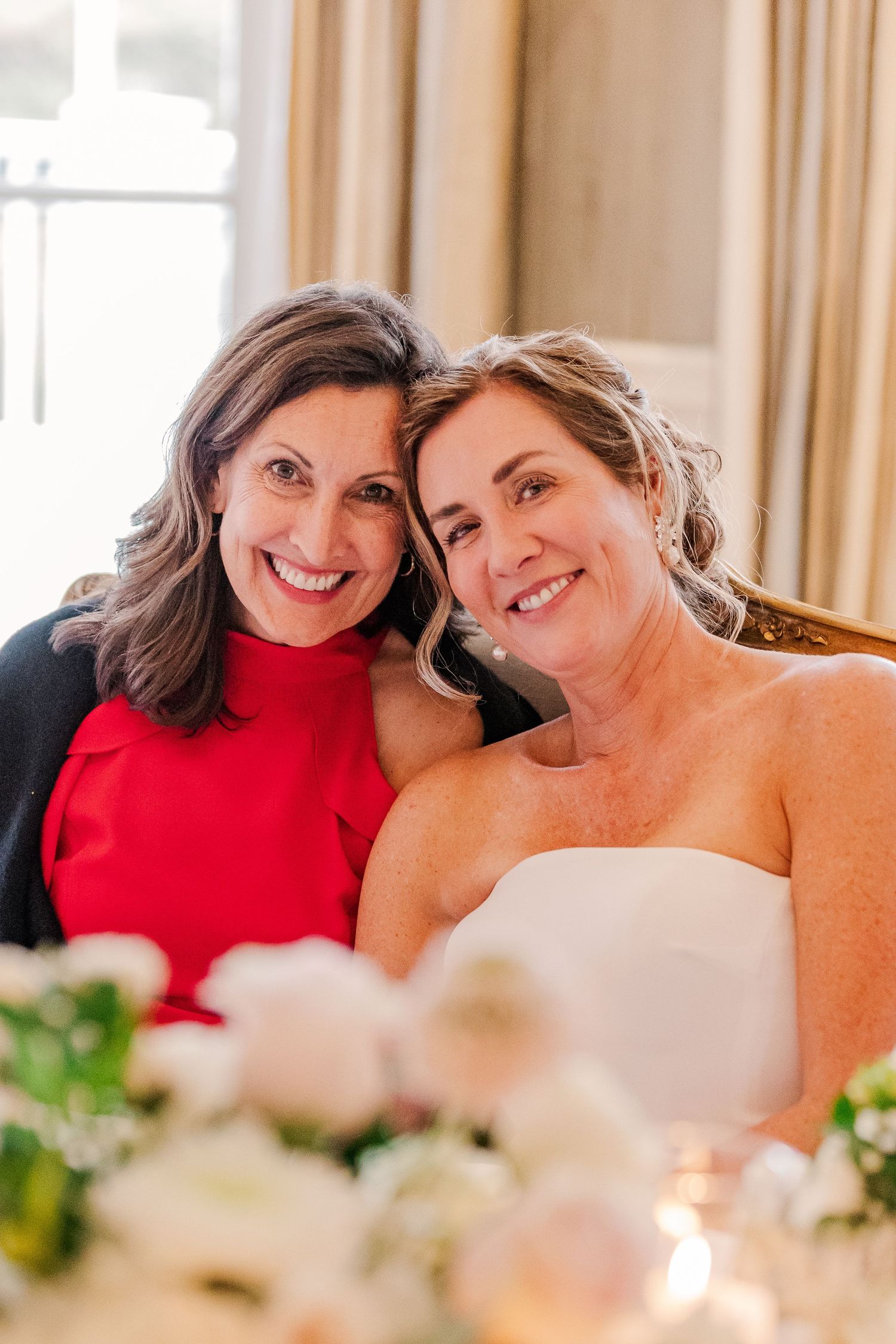 A heartwarming candid portrait showing shared laughter at elegant celebration.
