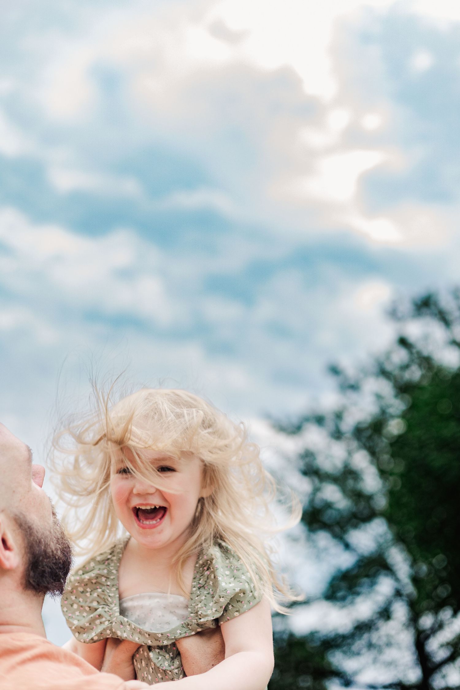 Pure joy and laughter captured during an outdoor playtime moment.