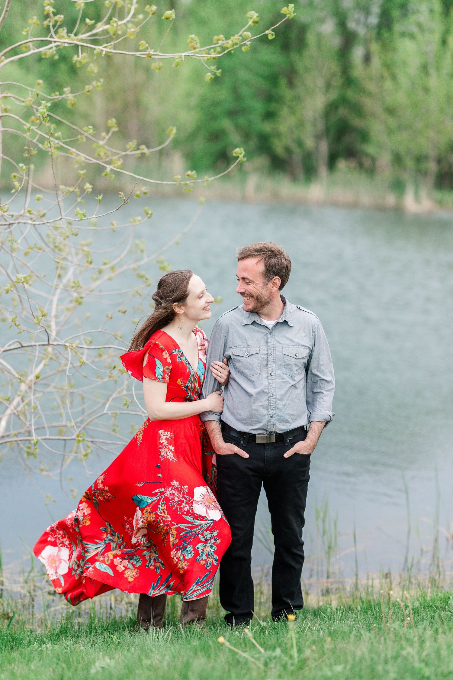 A windswept moment by the lake with her red dress flowing in the spring breeze.