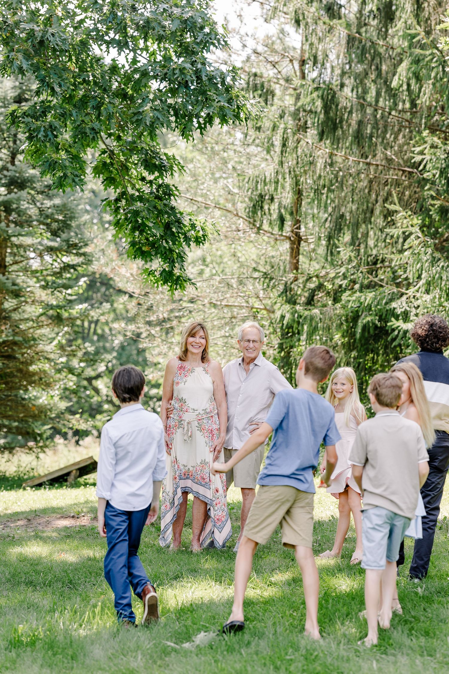 Children running toward family during a playful extended family session in Crystal Lake, Illinois.