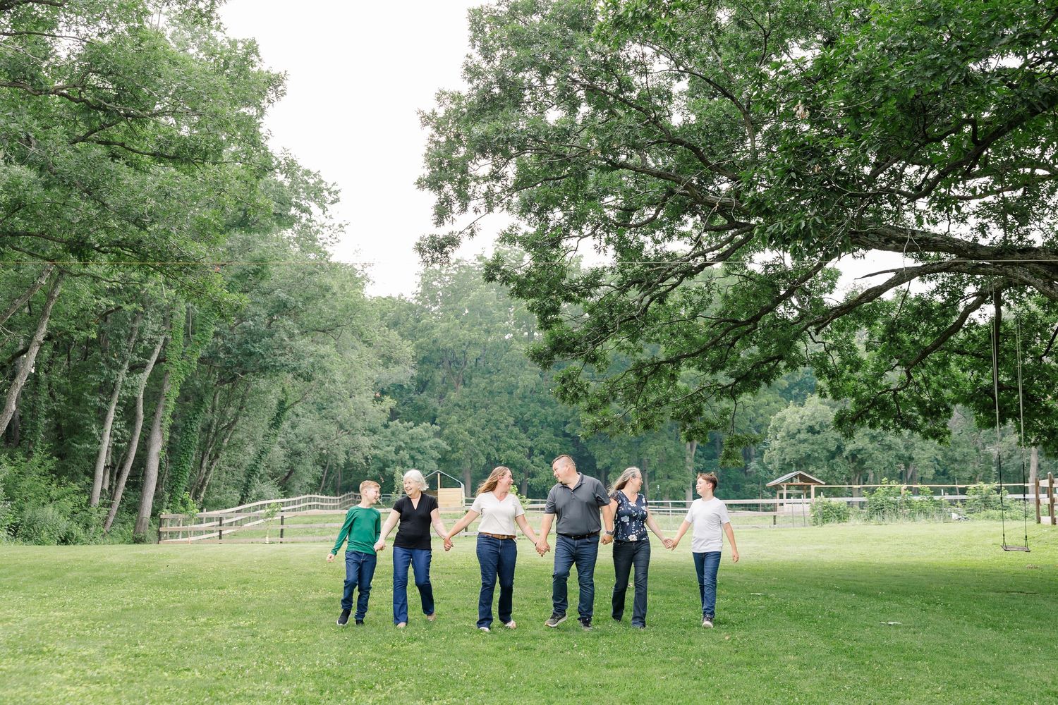 Extended family standing together in the evening light at their Bull Valley, Illinois home.