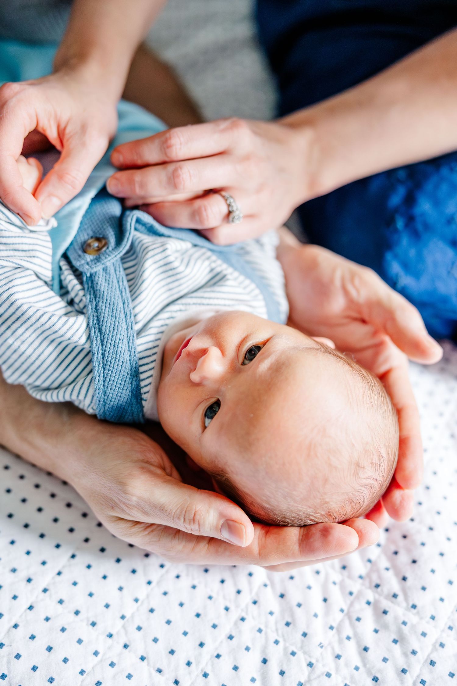 Close-up of newborn baby boy on bed during in-home lifestyle newborn session in Crystal Lake, Illinois