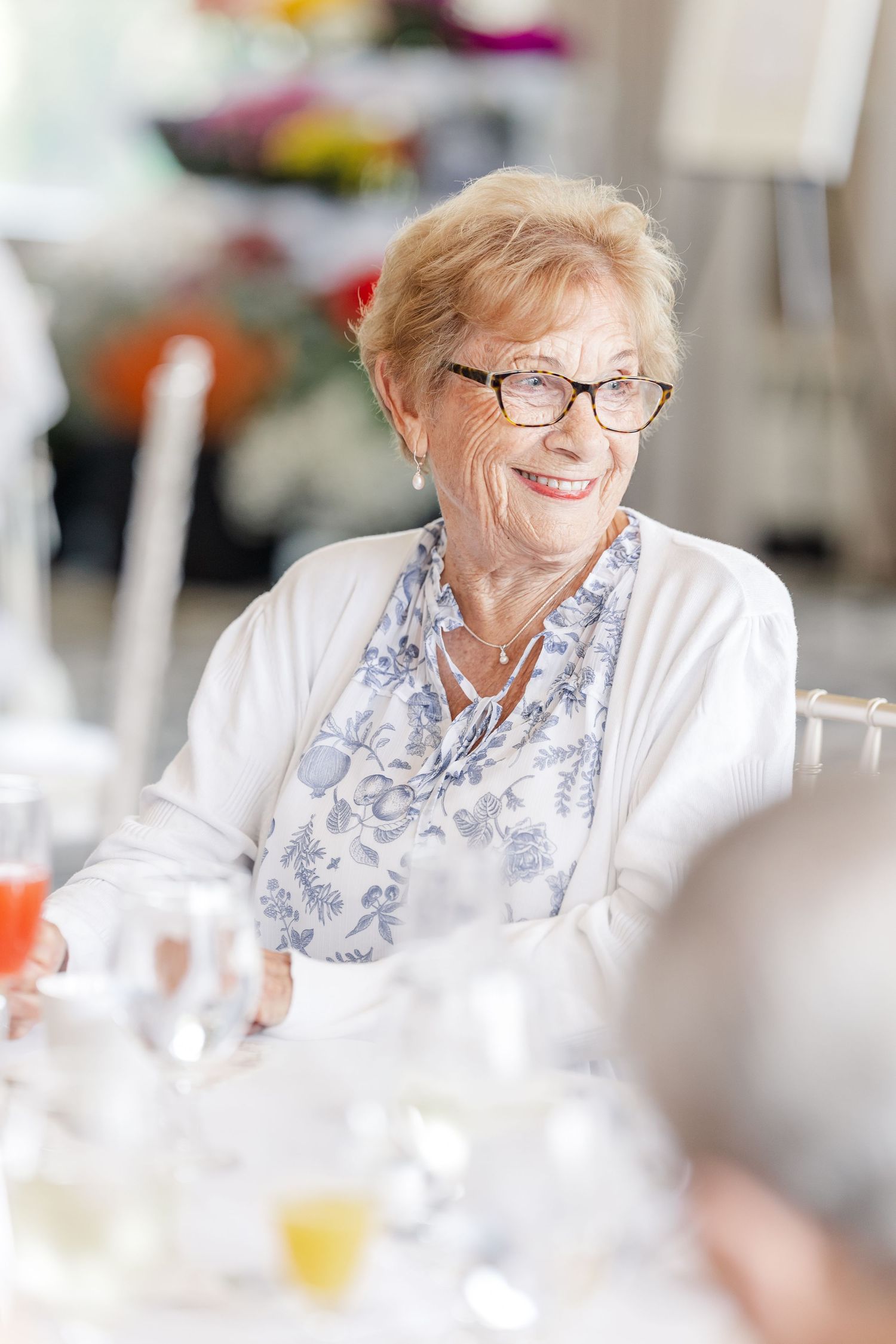 Guest smiling at table setting during Sarah's Itasca bridal shower