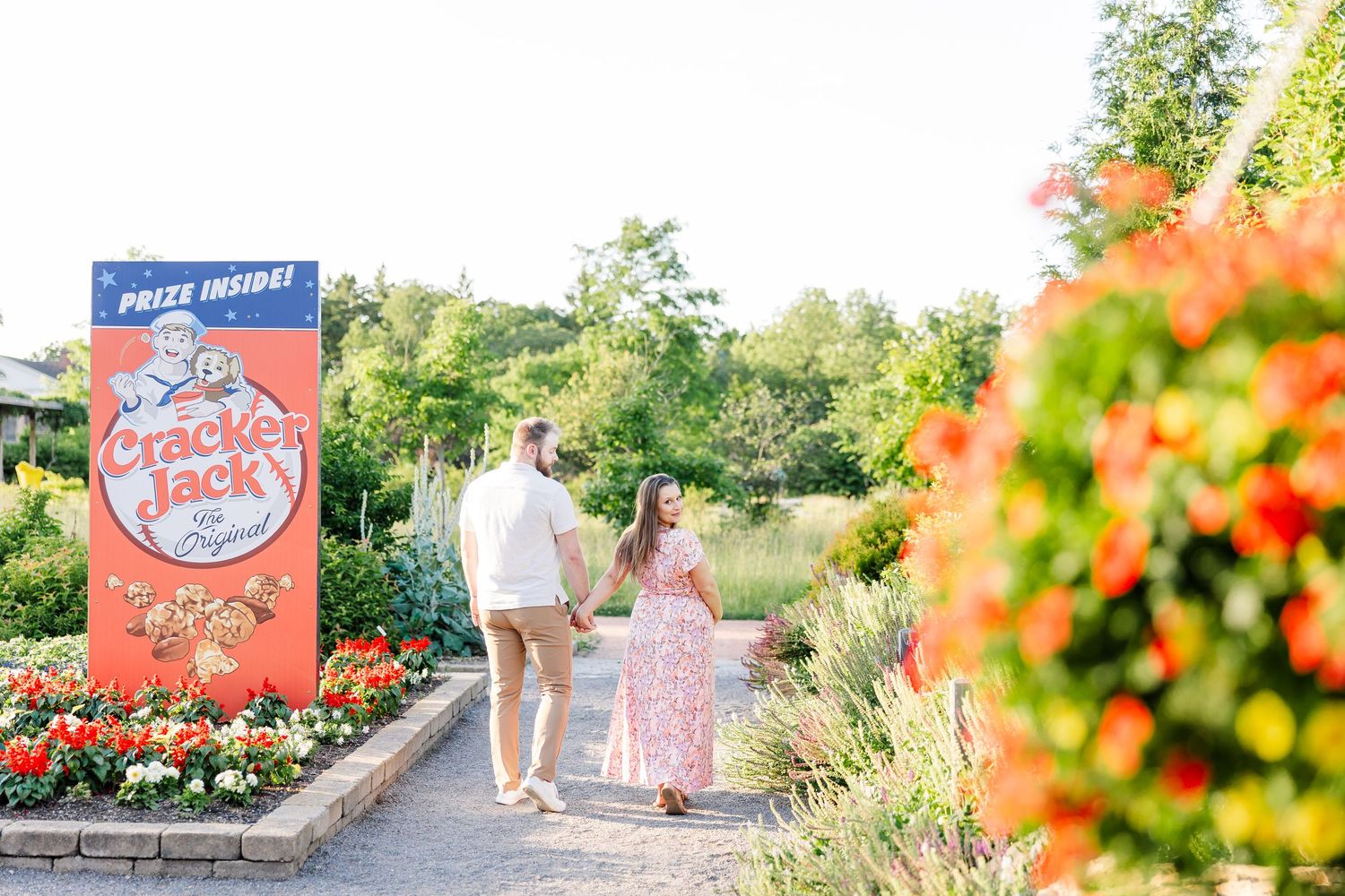 Expecting parents walking near the colorful Cantigny Park gardens during their Wheaton maternity session