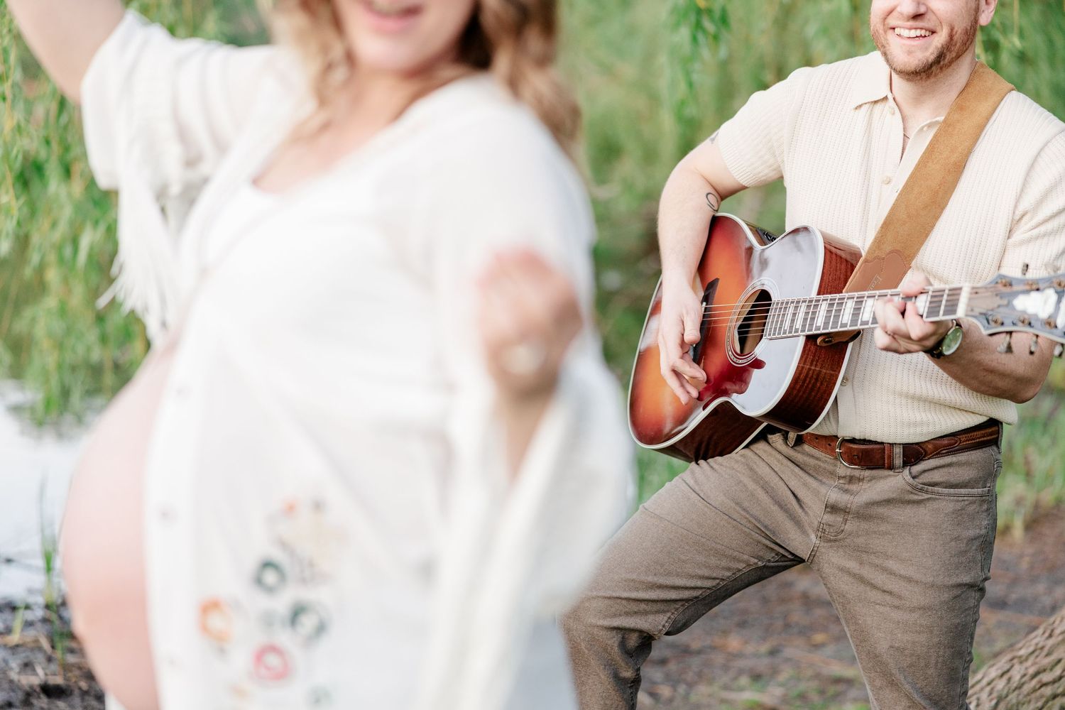 Music-inspired maternity detail with baby bump and guitar during a Crystal Lake maternity session.