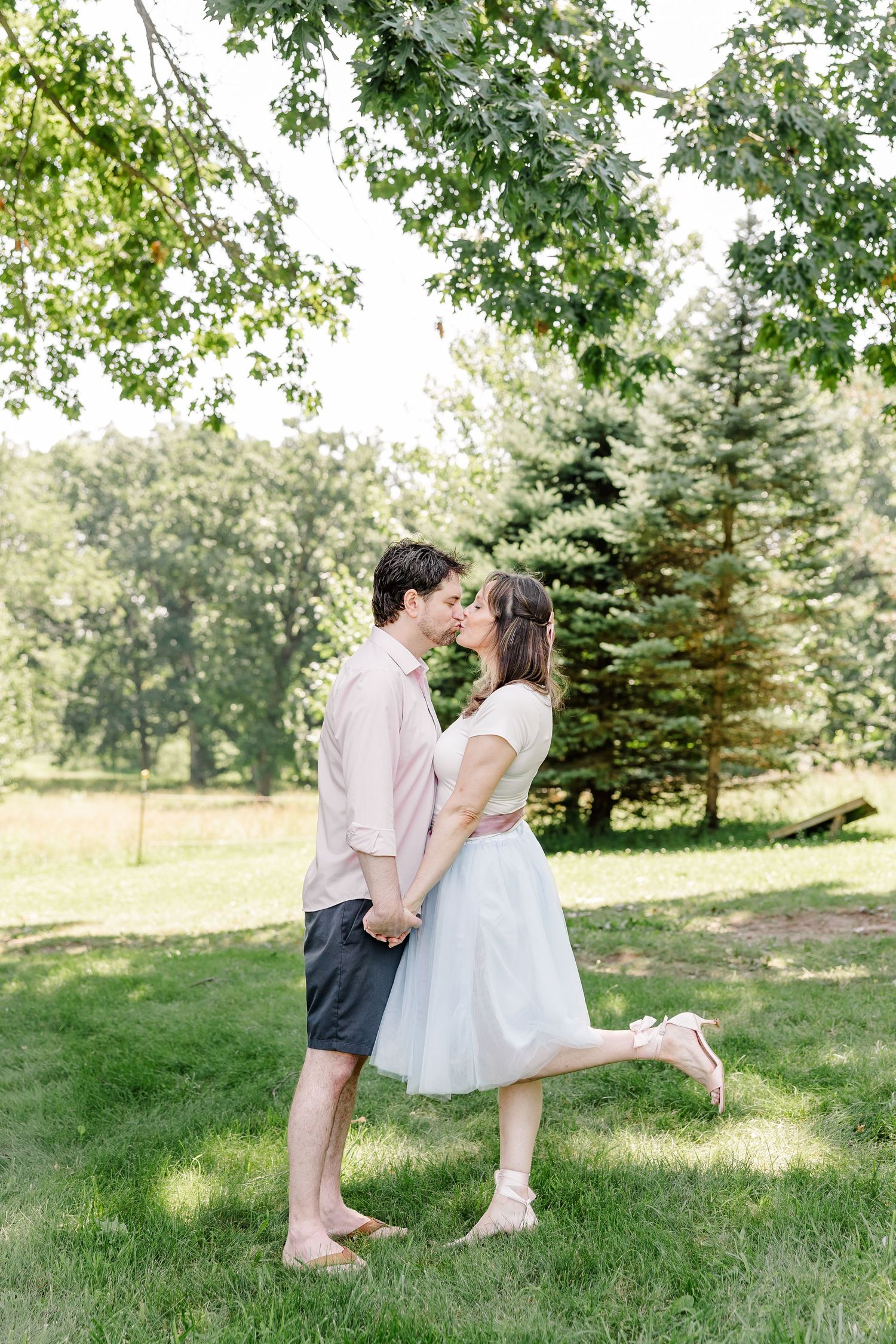 Couple sharing a kiss during a summer family reunion session in Crystal Lake, Illinois.