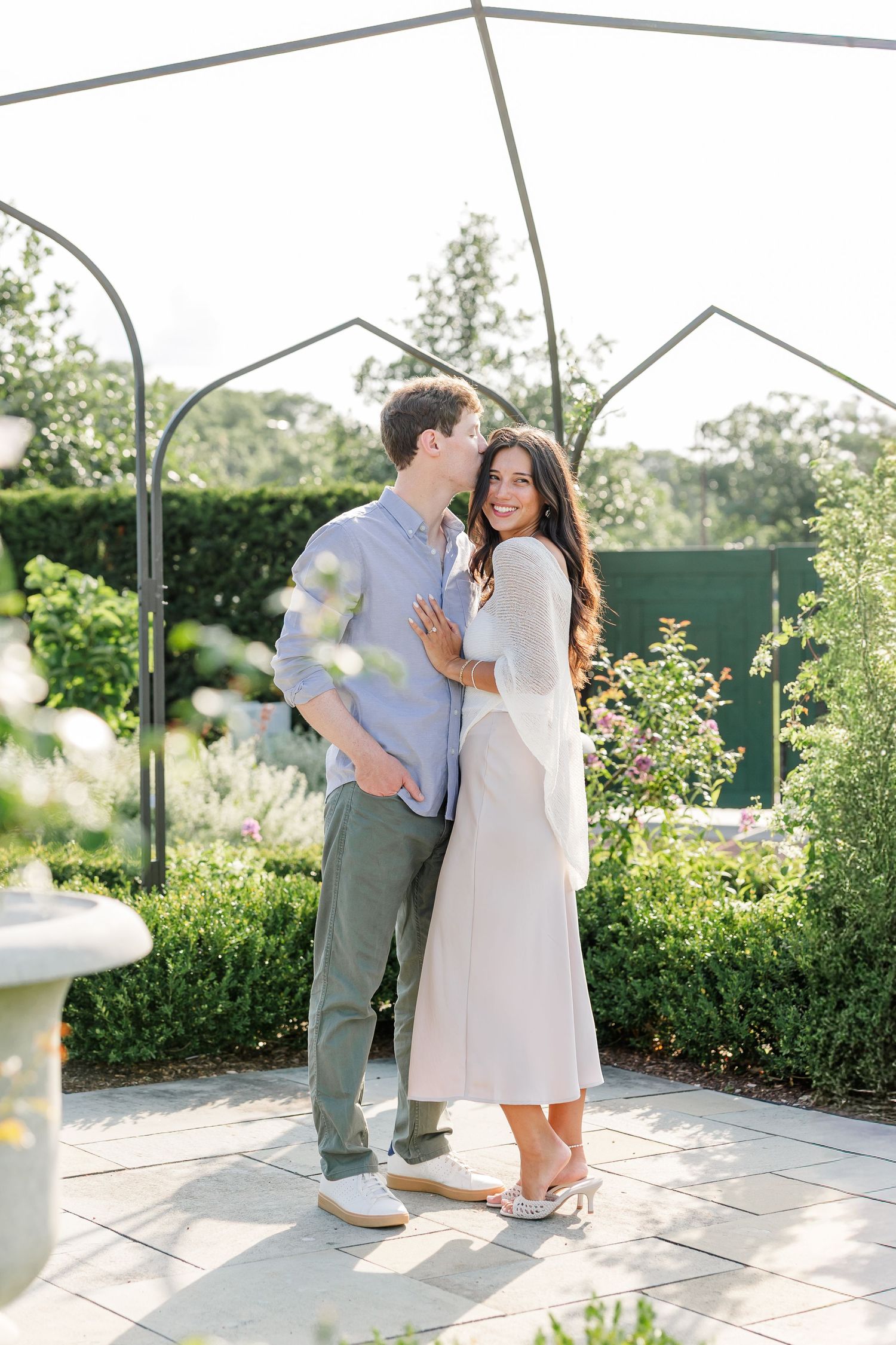 Alysia and Jack embrace among the flowers during their Cantigny Park proposal portraits.