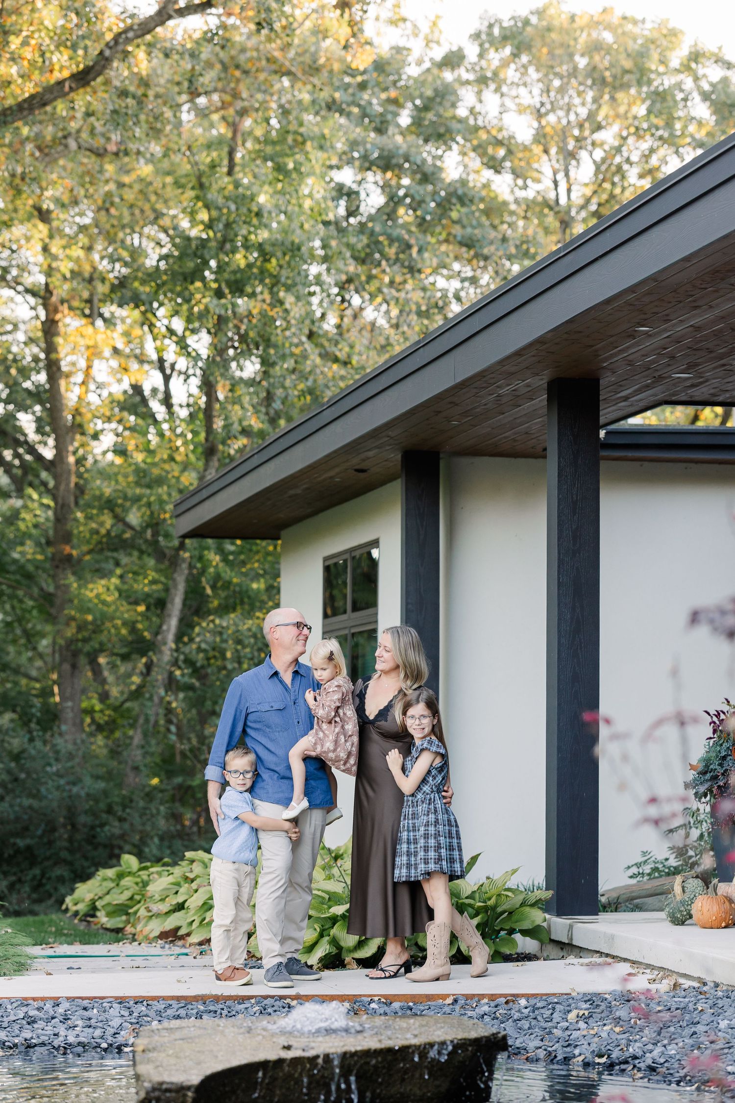 Family of five gathered outside their home during fall family portraits in St. Charles, IL.