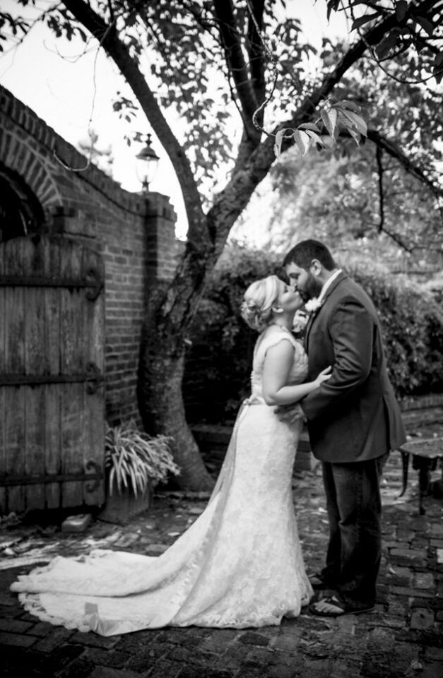 Black and white wedding photos showing couple in garden setting with vintage ambiance.