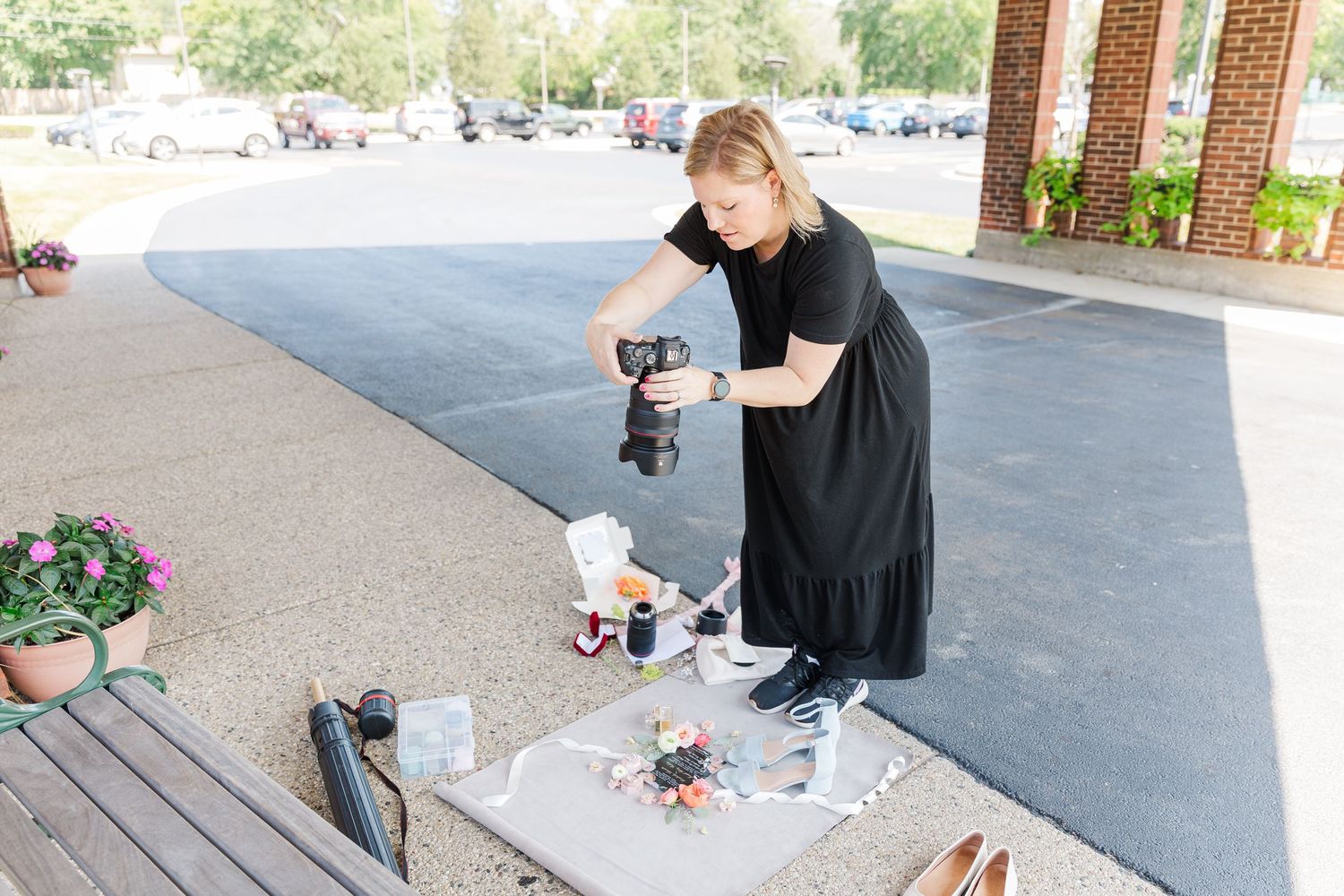 Cassie Lacina styling wedding details outdoors before photographing them