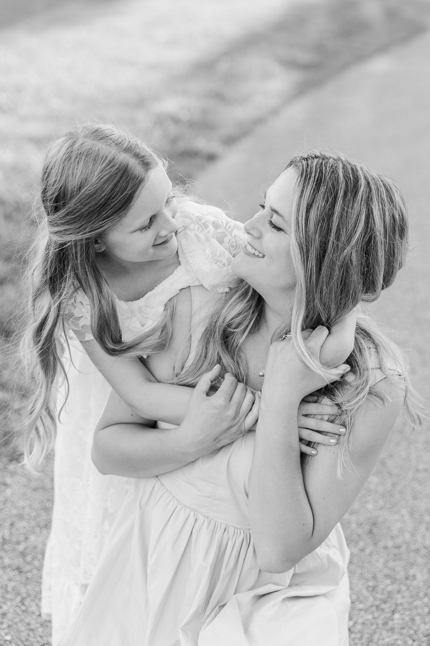 A touching black and white portrait of intimate affection between parent and child.