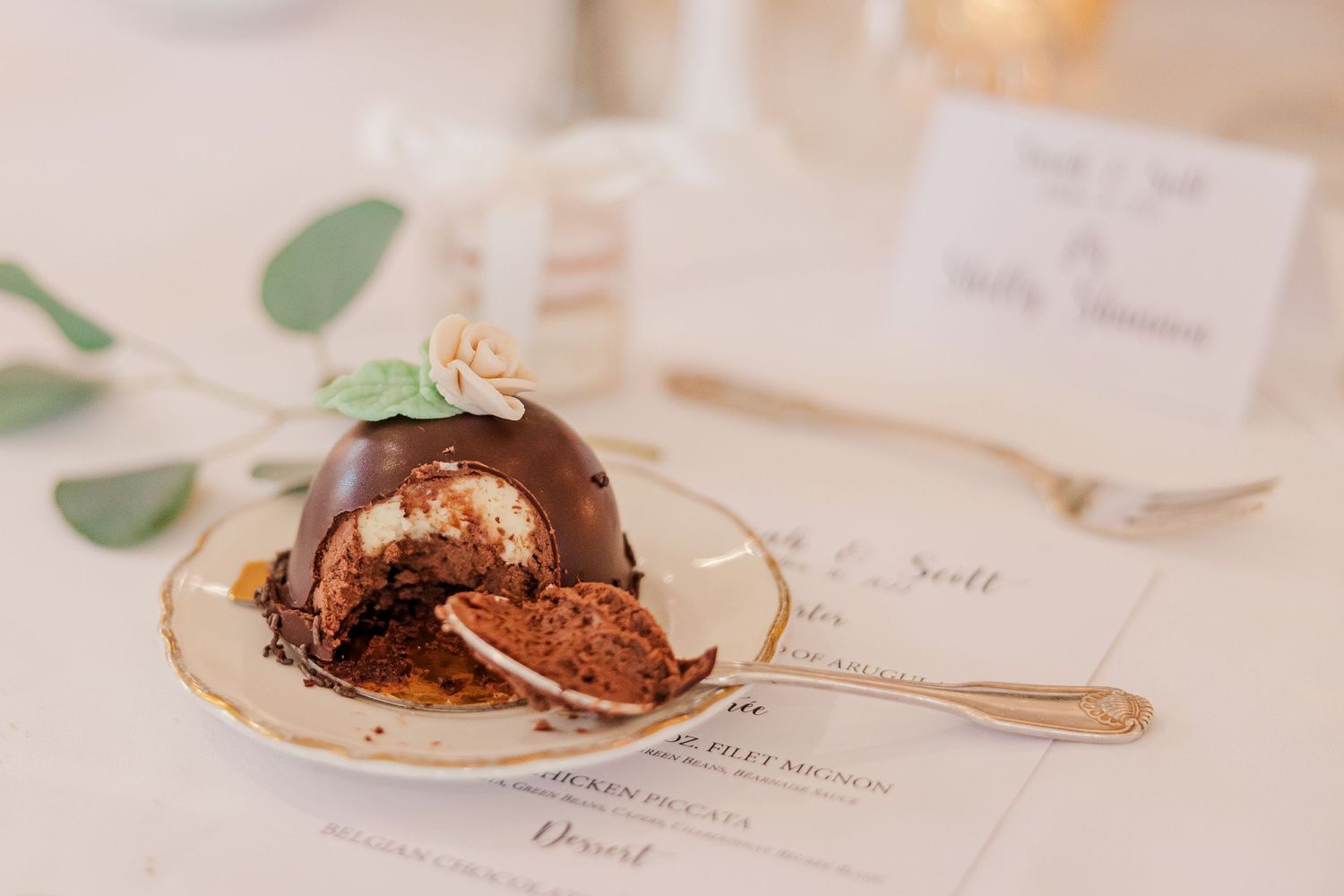 Sliced chocolate dome dessert showing rich interior layers on a menu card.