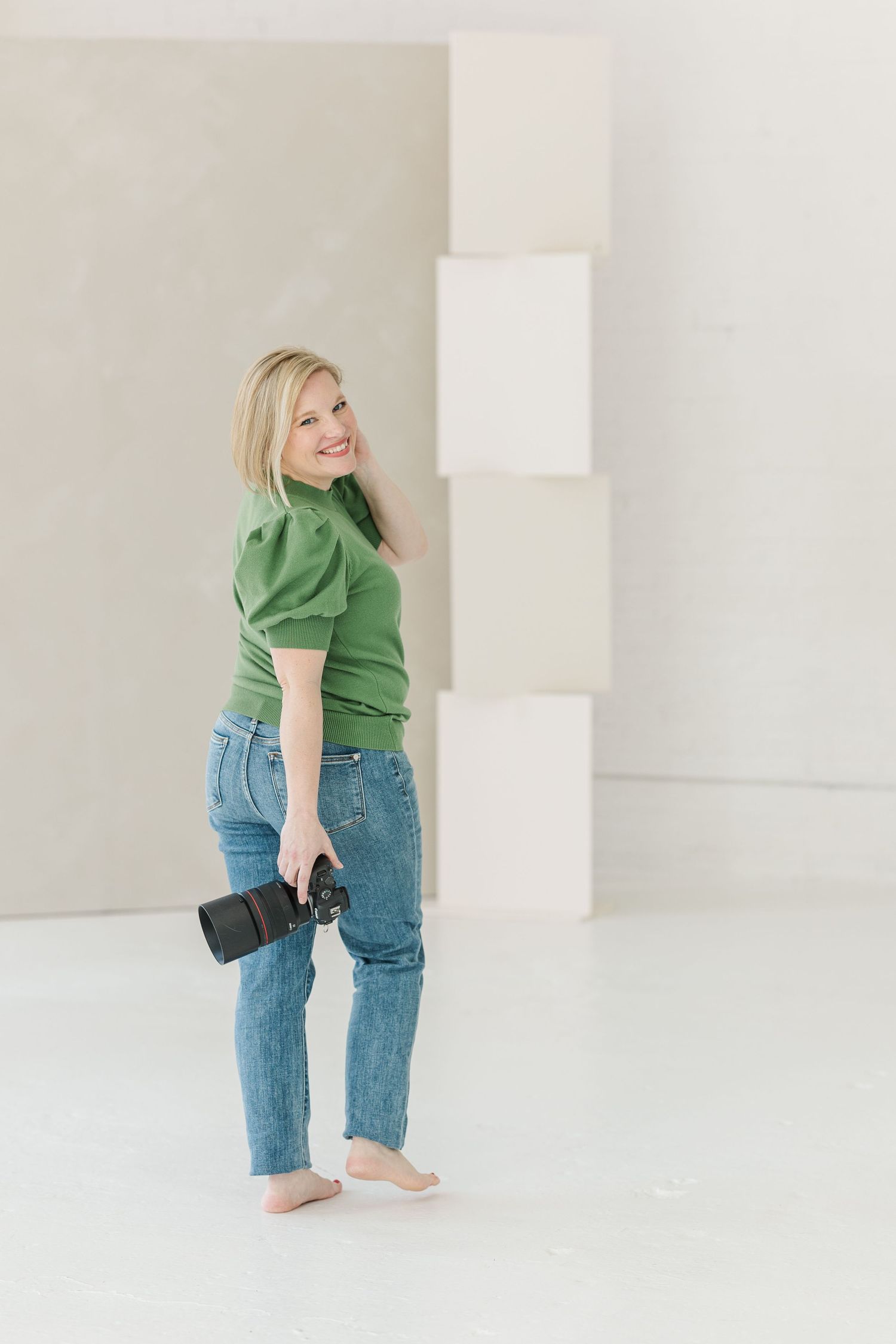 Cassie Lacina photographer branding portrait in studio for contact page