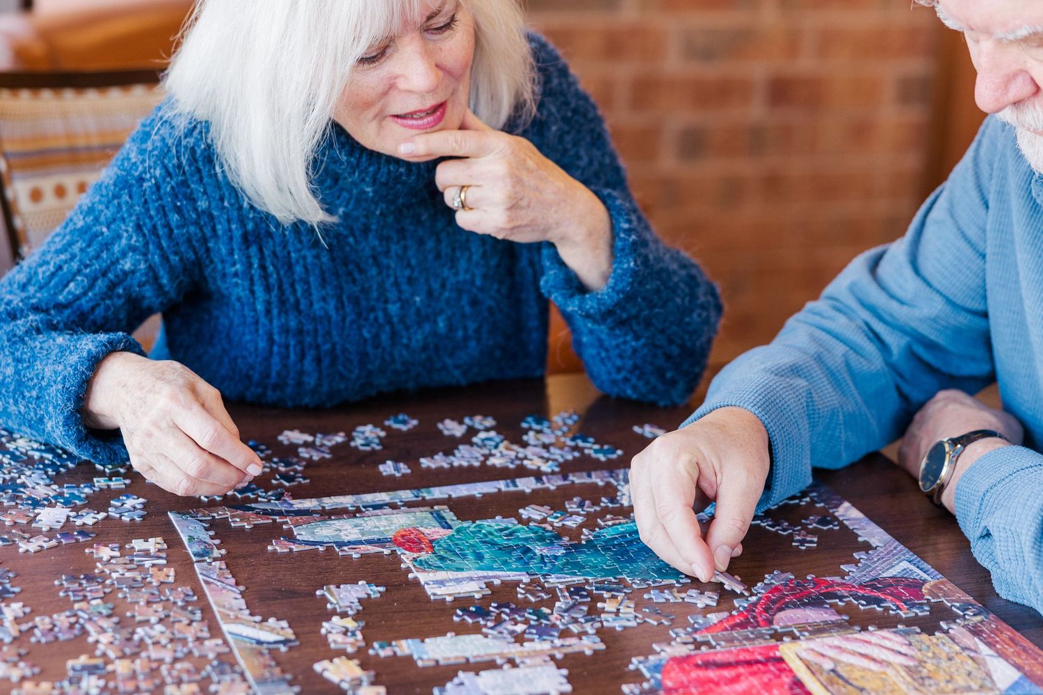 Beacon Hill senior living branding photo in Lombard, Illinois featuring residents working on puzzle together