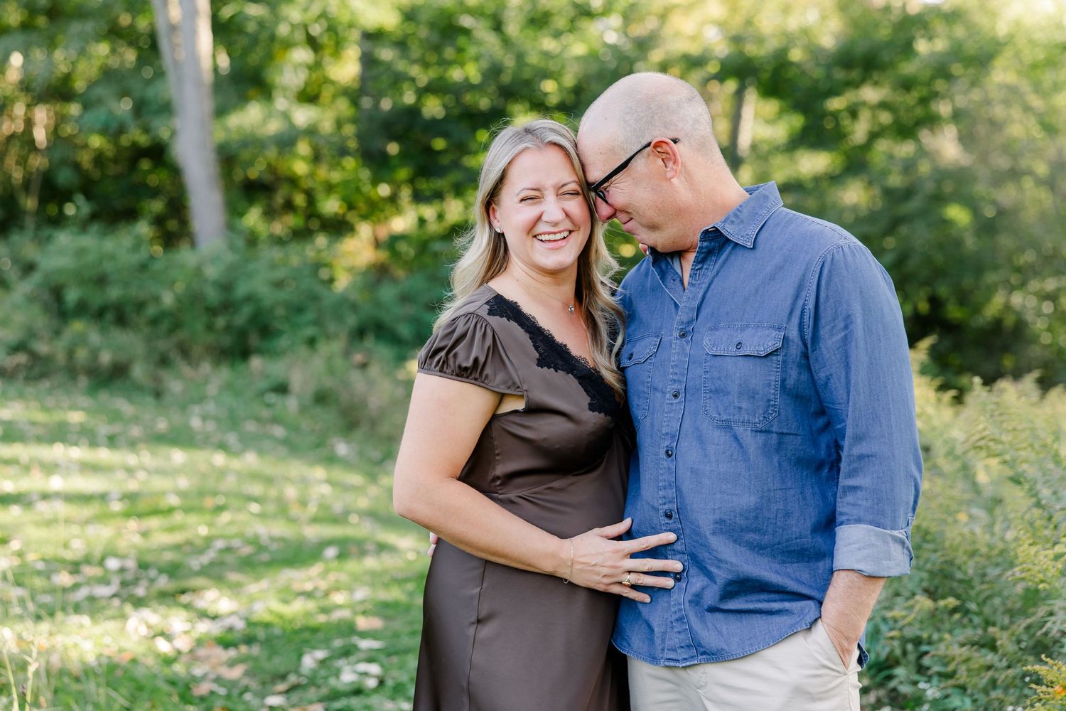 Husband leaning close to his smiling wife during backyard portraits in St. Charles, IL.