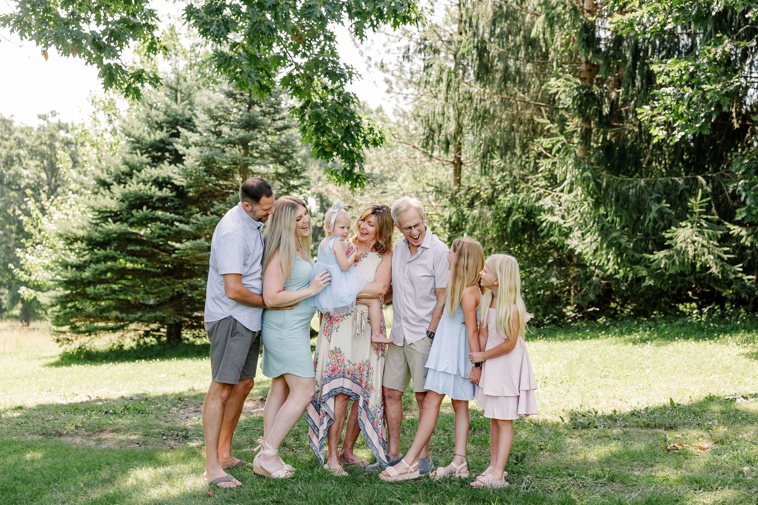 Grandparents sharing a sweet moment with grandchildren during a summer family reunion photo session in Crystal Lake, IL.